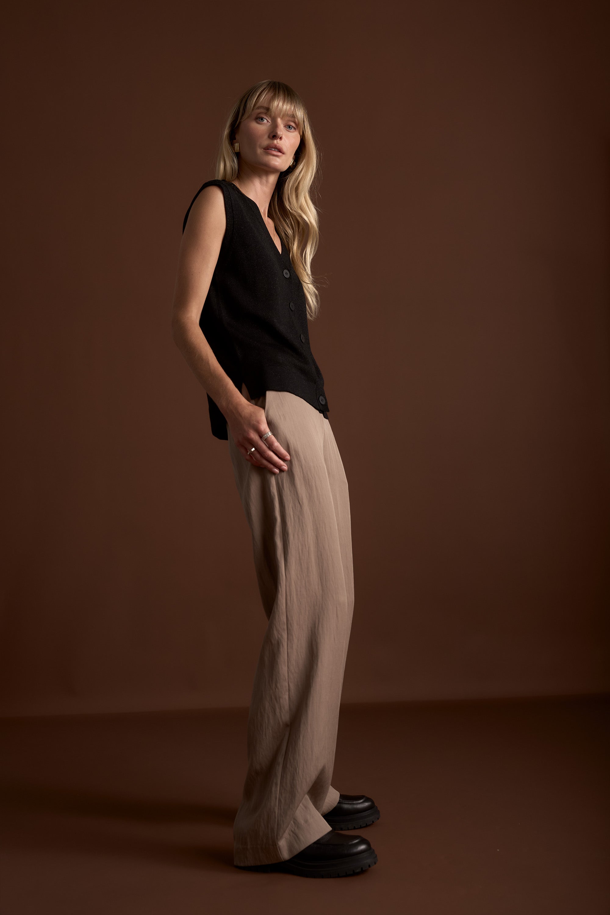 Woman in The Ultimate Wide Leg Pants by Max stands against a brown background.
