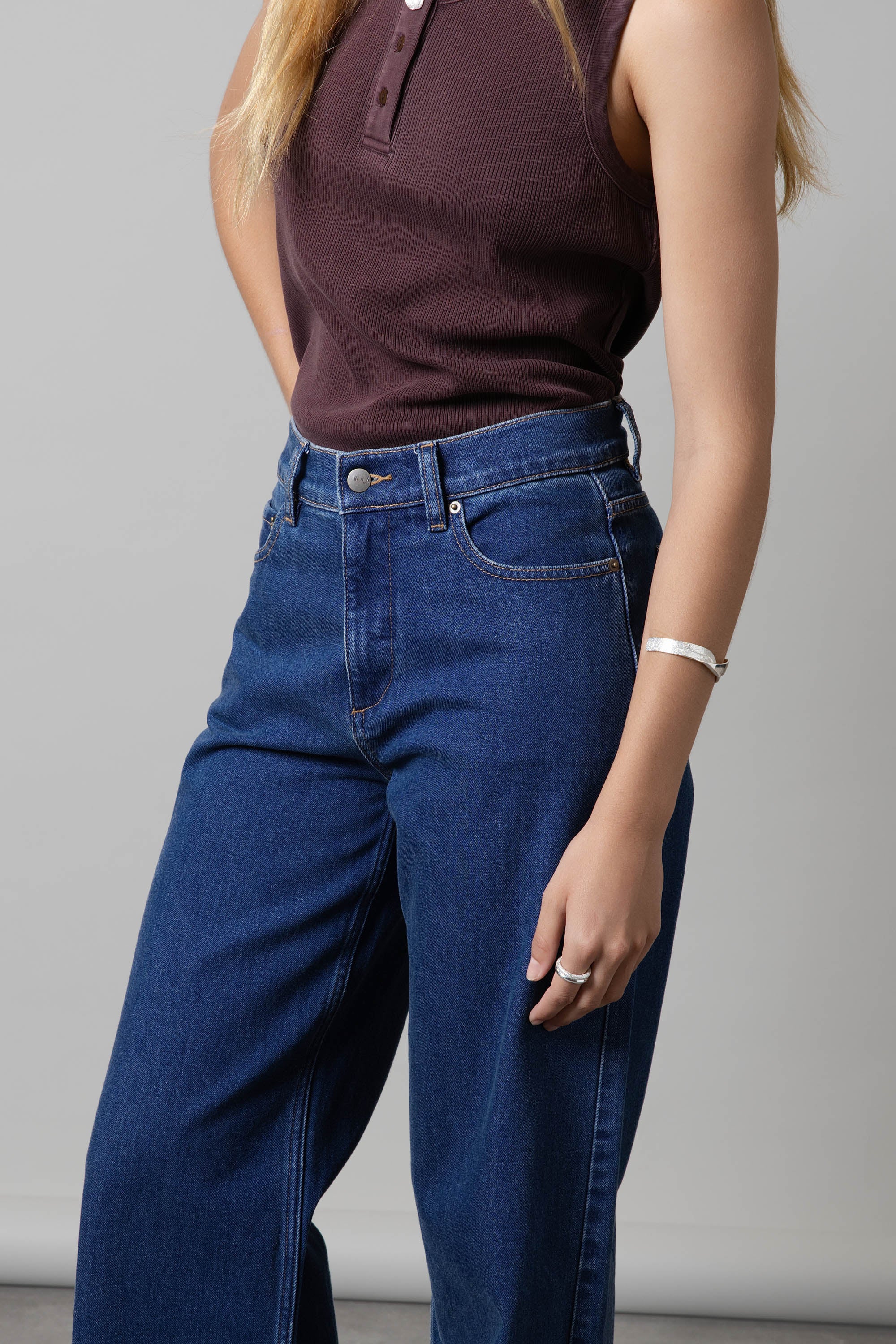 Woman in maroon top and Max Nevada Wide Jeans, styled with a bracelet and ring.