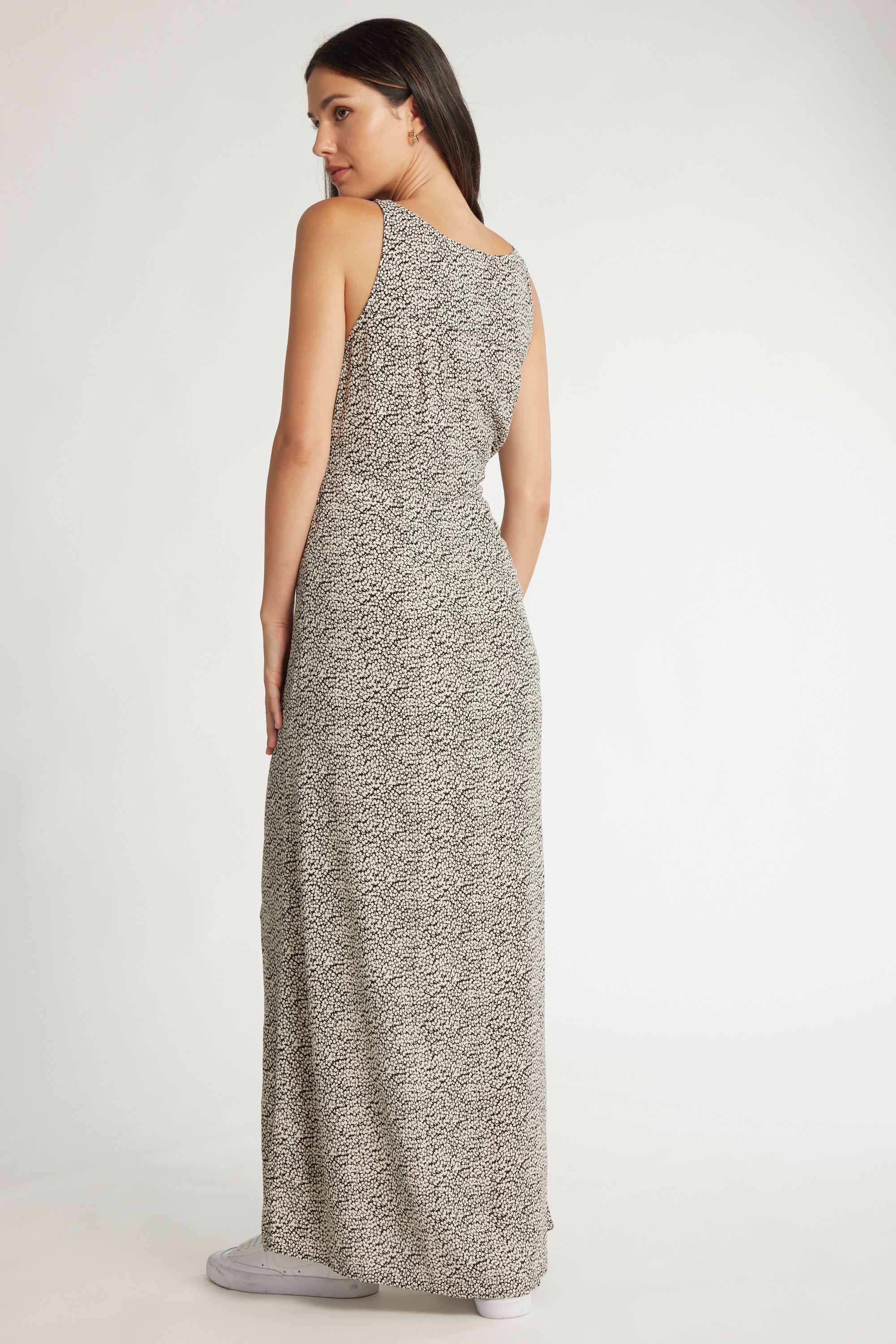 Woman in a Max Miley Midi Dress, standing and looking over her shoulder.