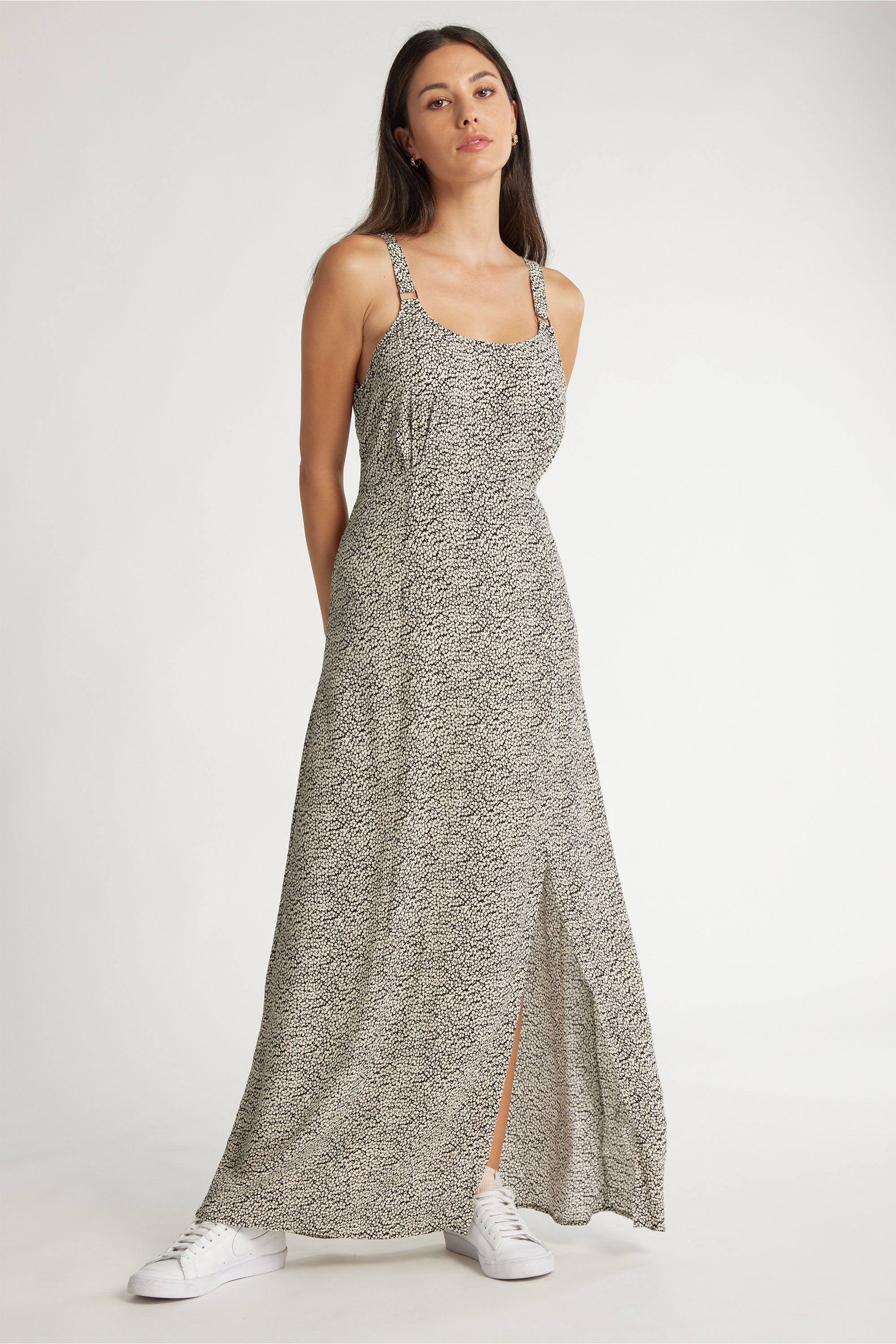 Woman in Max's Miley Midi Dress and white sneakers, standing against a plain background.