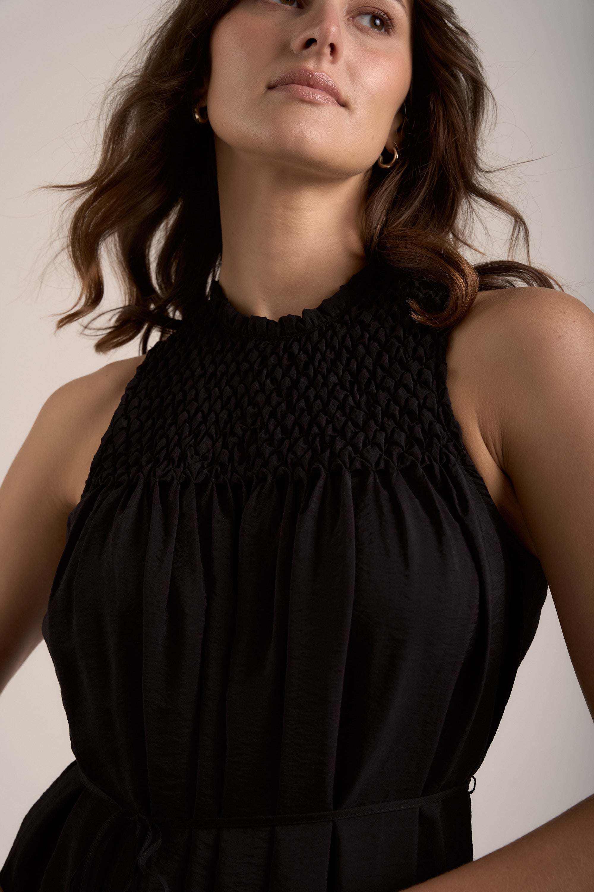 Woman wears the Max Sherry Smock Detail Dress, looking slightly upward.