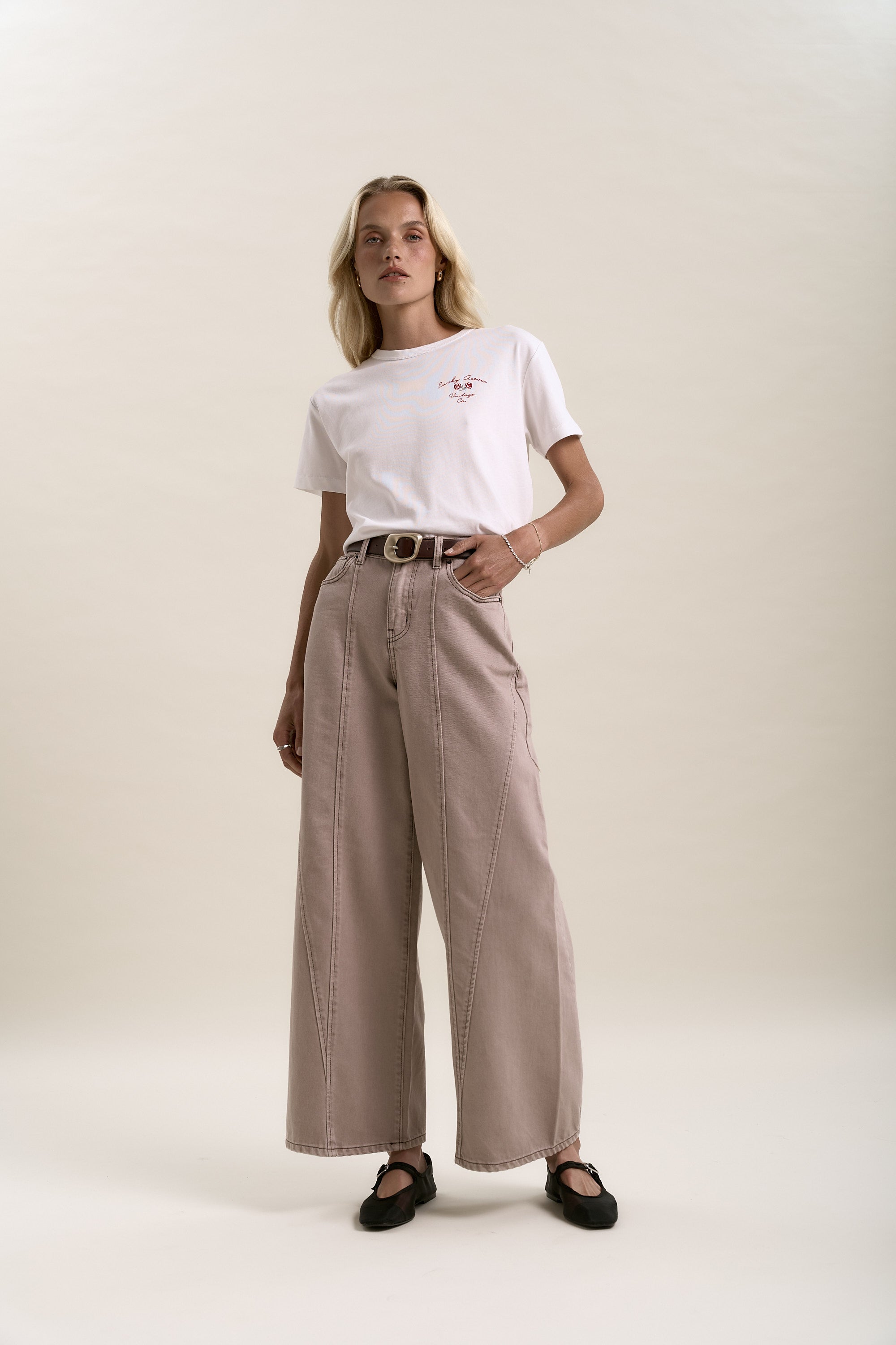 Model in Lisbon Panel Detail Jeans by Max, styled with a white tee against a plain backdrop.