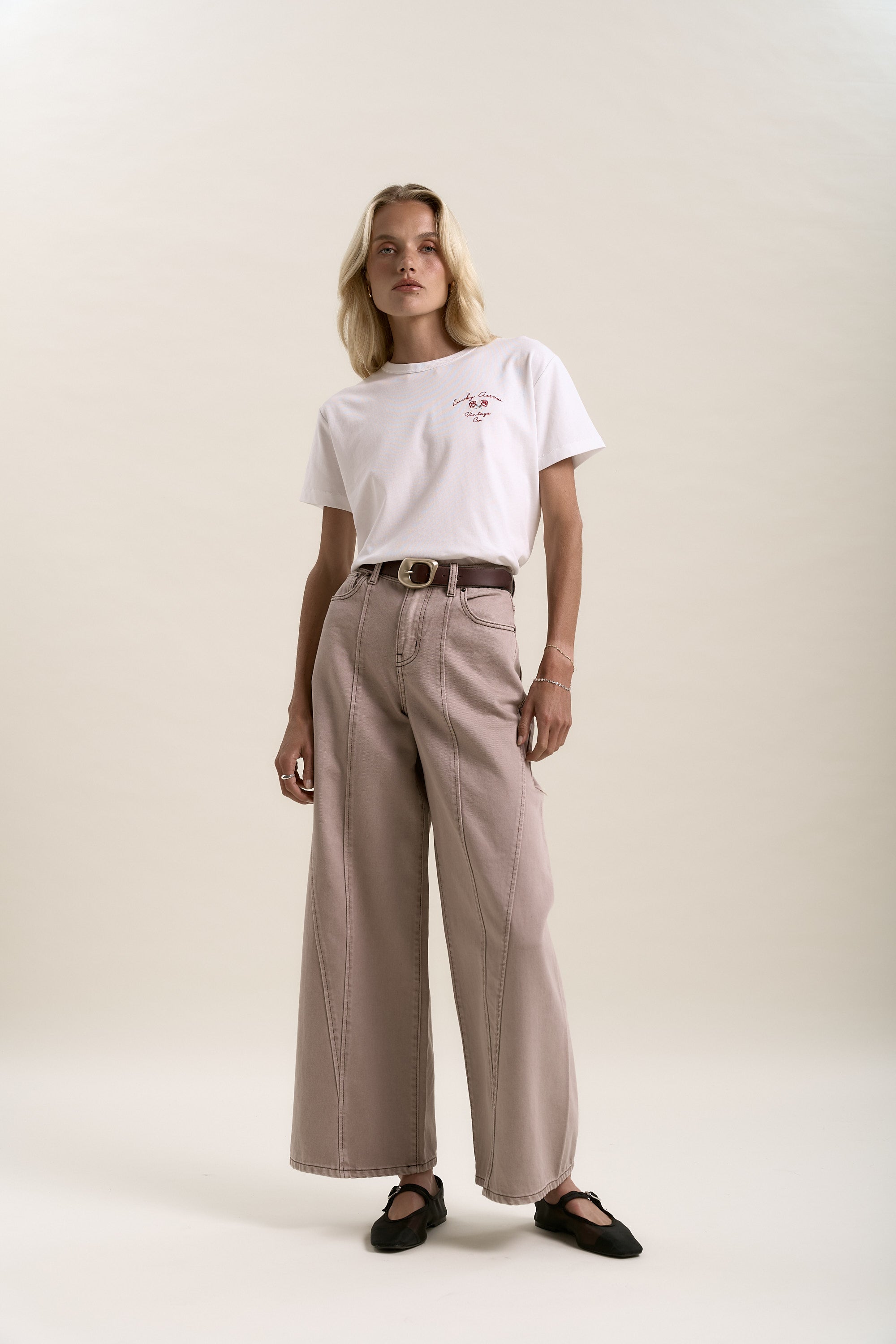 Woman in a white t-shirt and Max Lisbon Panel Detail Jeans against a plain background.