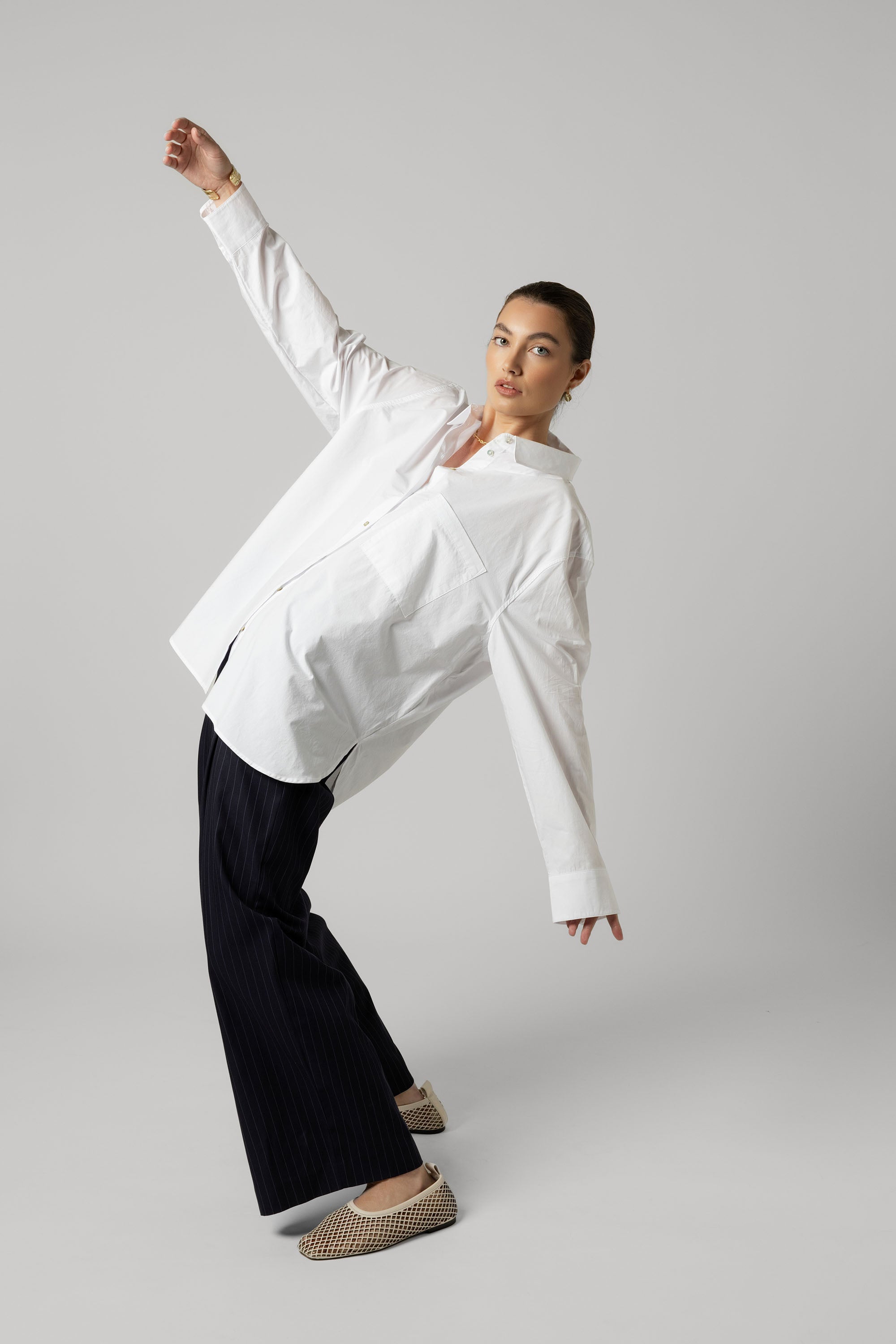 A woman in the Max Everyday Tailored Shirt poses against a plain light gray background.
