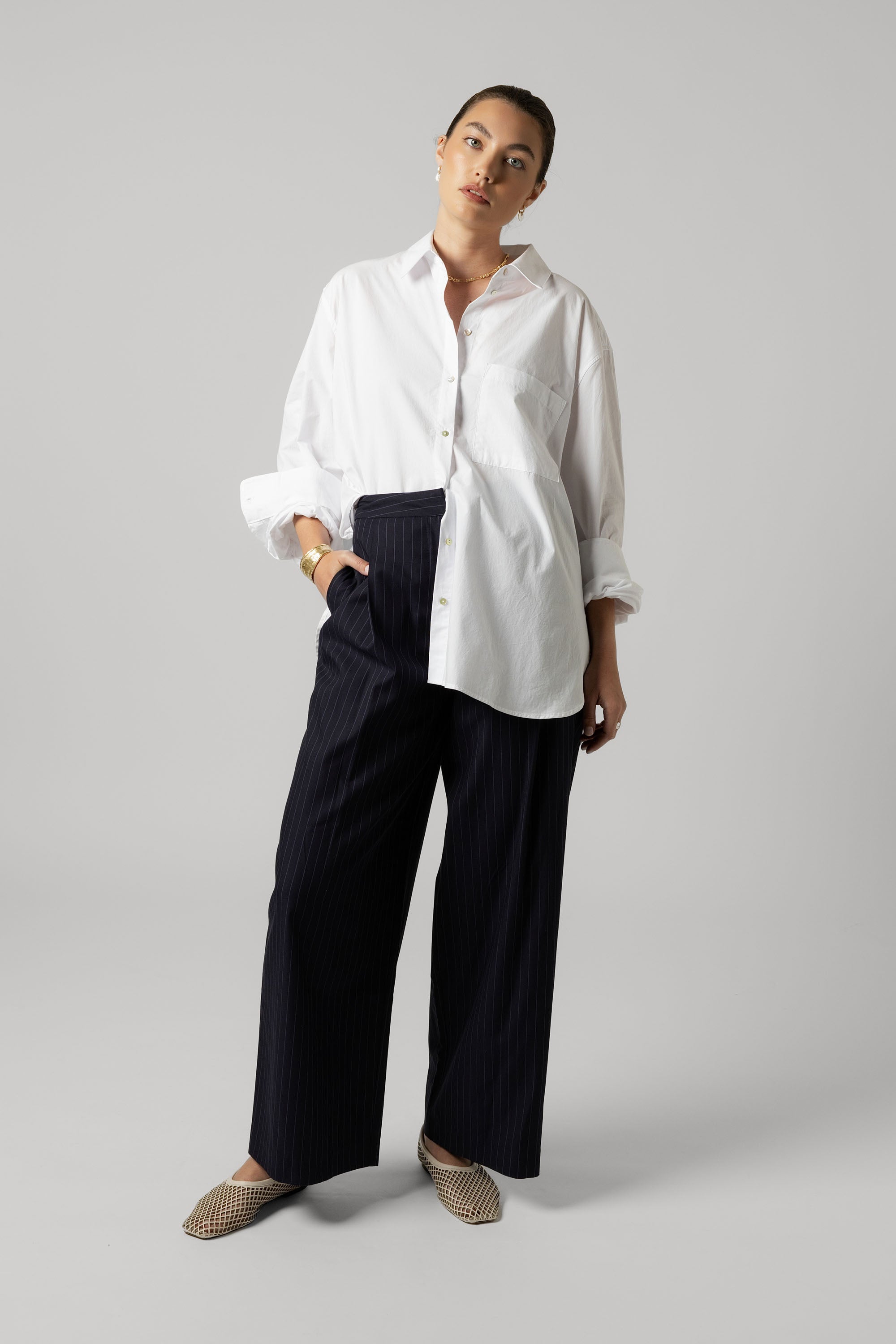 Model wears the Max Everyday Tailored Shirt with black wide-leg pants against a plain background.