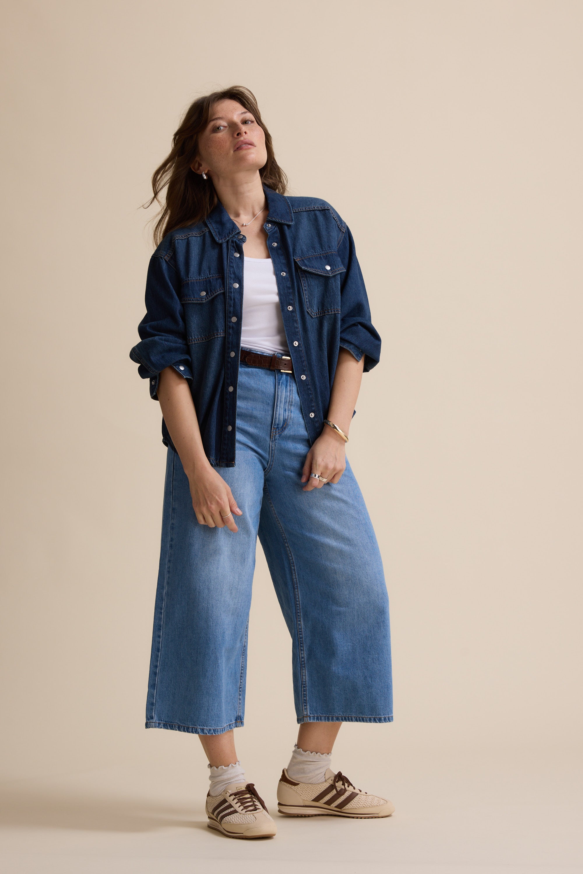 Woman in Max's Sabrina Cropped Denim Jacket poses against a plain beige background.