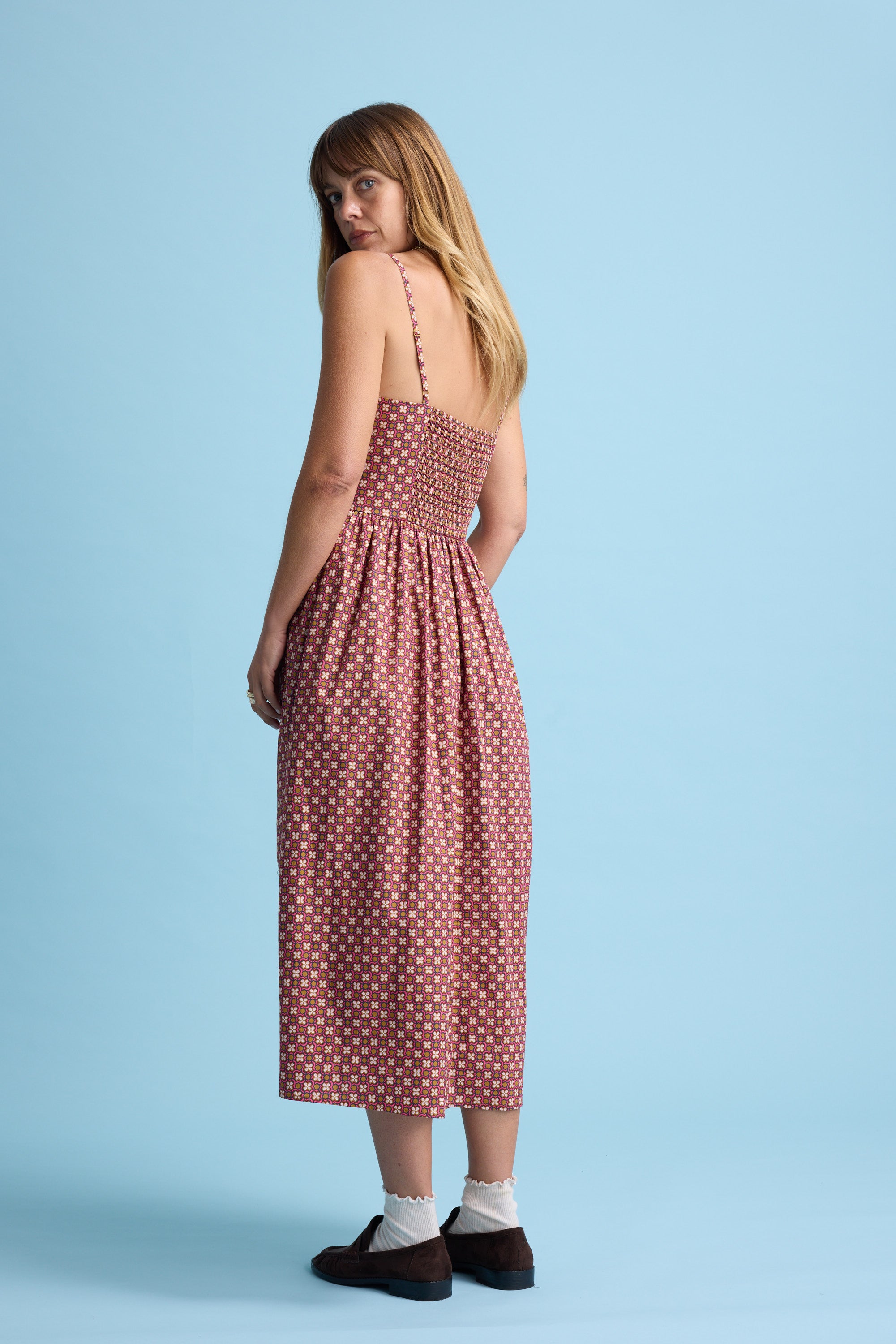 Woman in the Max Eliza Midi Dress stands against a light blue background.