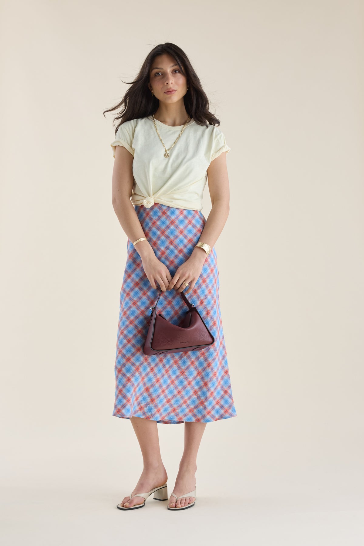 Woman in the Max Nina Bias Cut Dress radiates elegance.