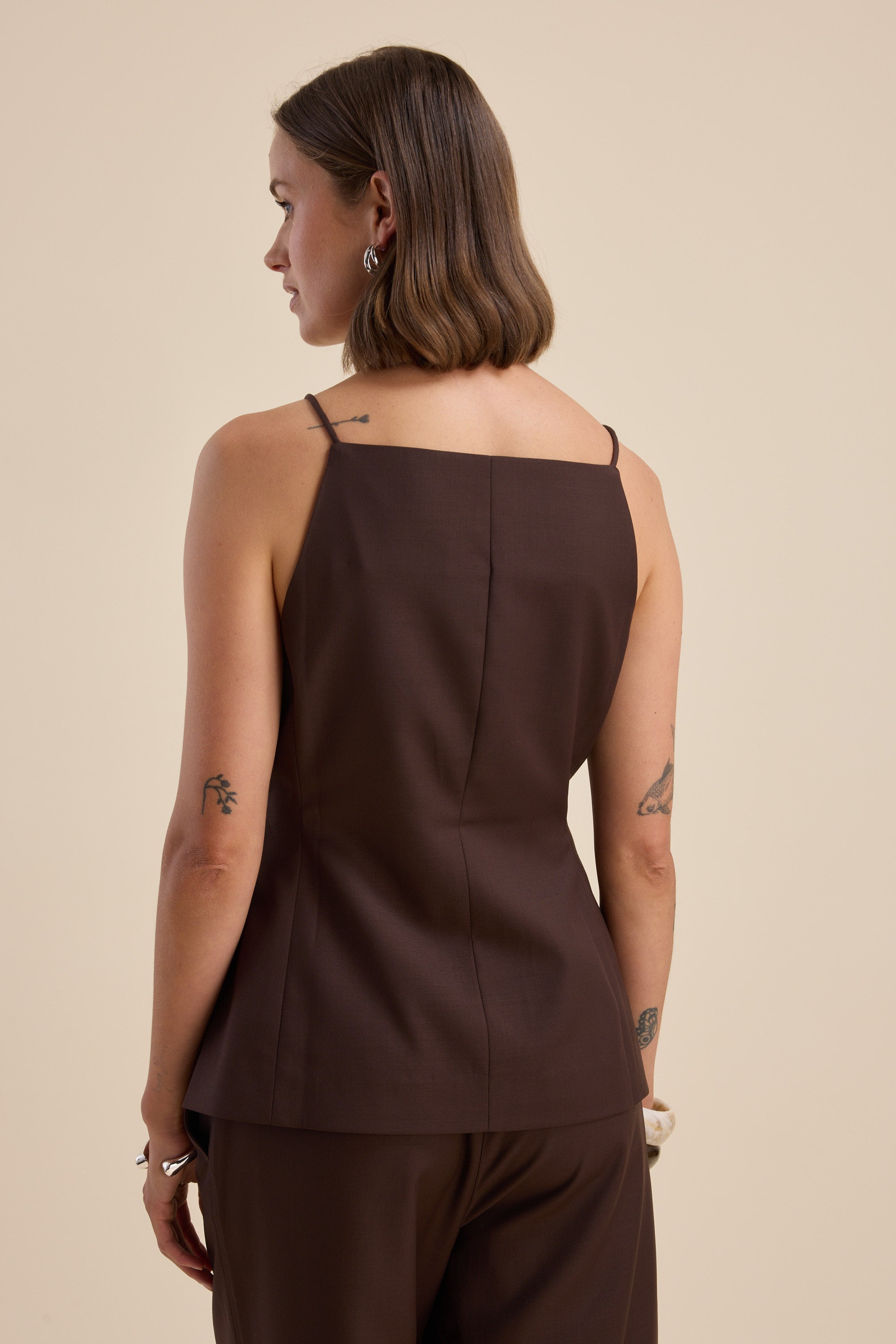 Woman in The Wool Blend Vest by Max, brown sleeveless, fit and flare, shown from the back.