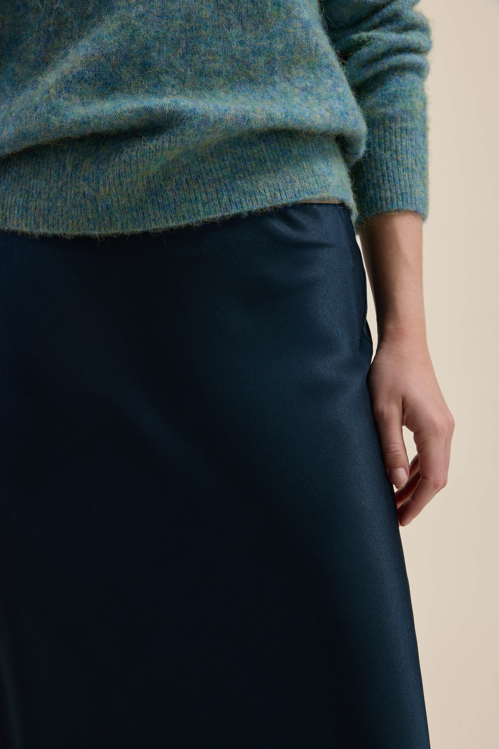 Person in a fuzzy green sweater and The Perfect Slip Skirt by Max in dark blue satin.