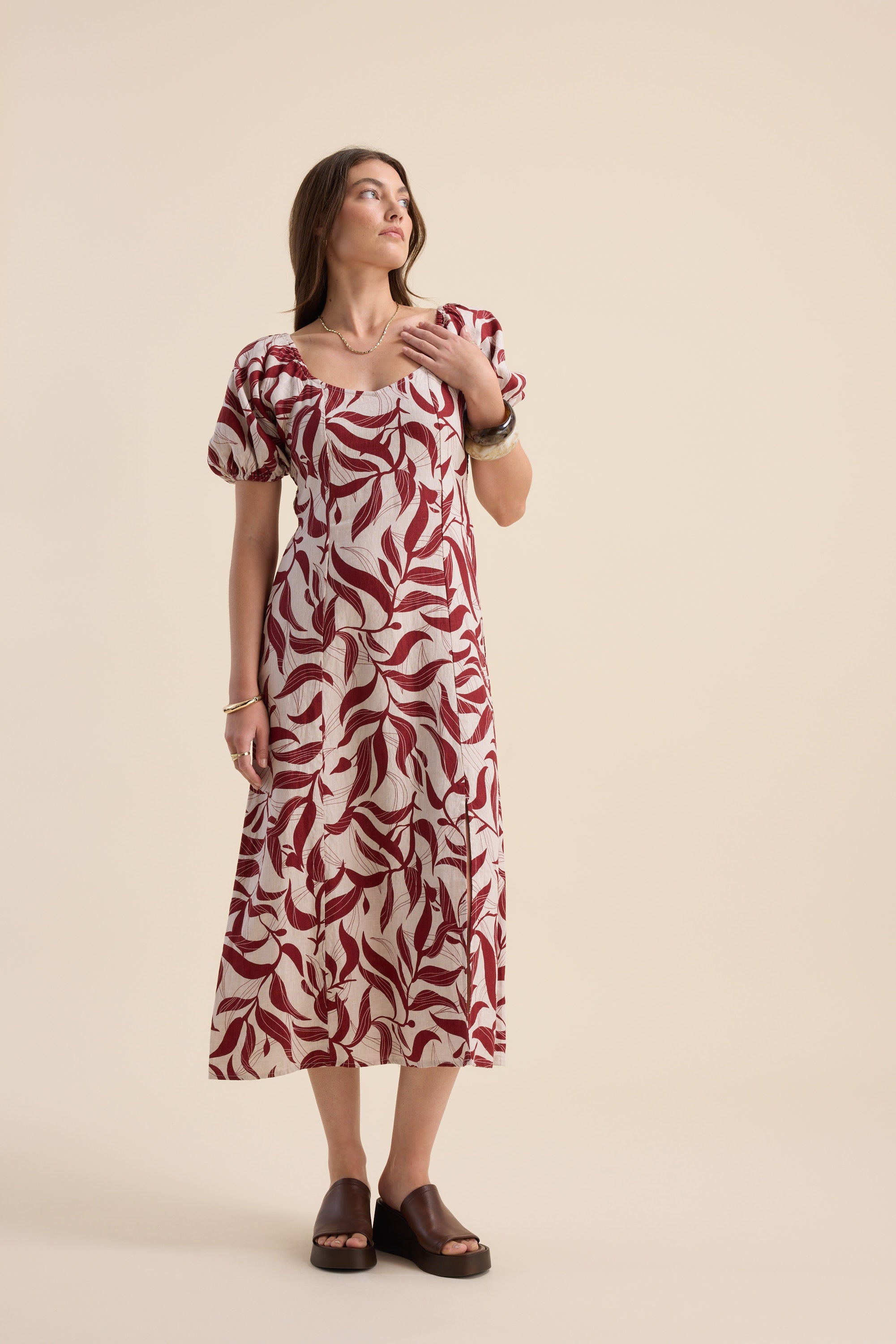 Woman wearing the Max Camille Puff Sleeve Dress with brown sandals.