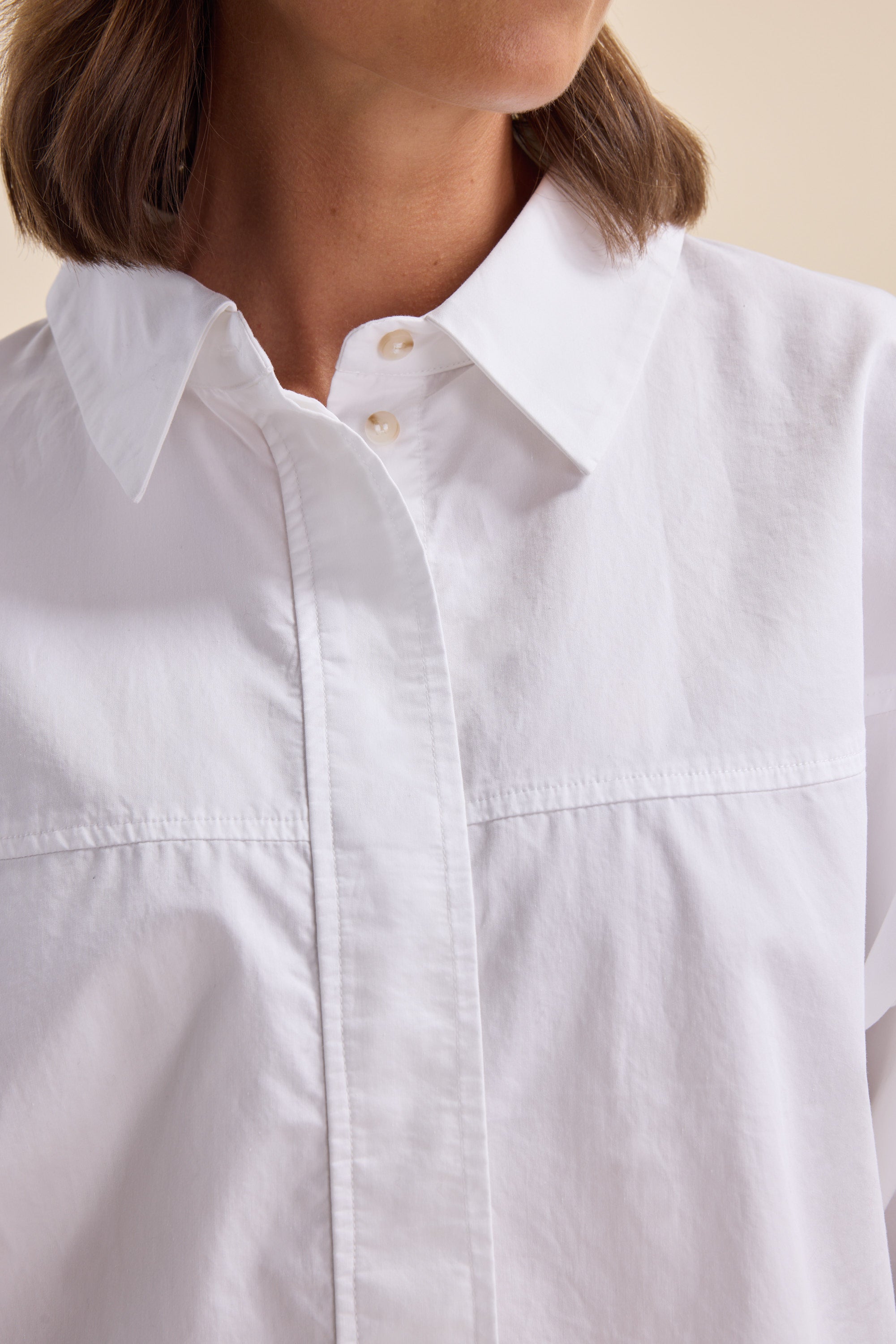 Woman in the Elementary Yoke Detail Shirt by Elementary, photographed from the shoulders up.