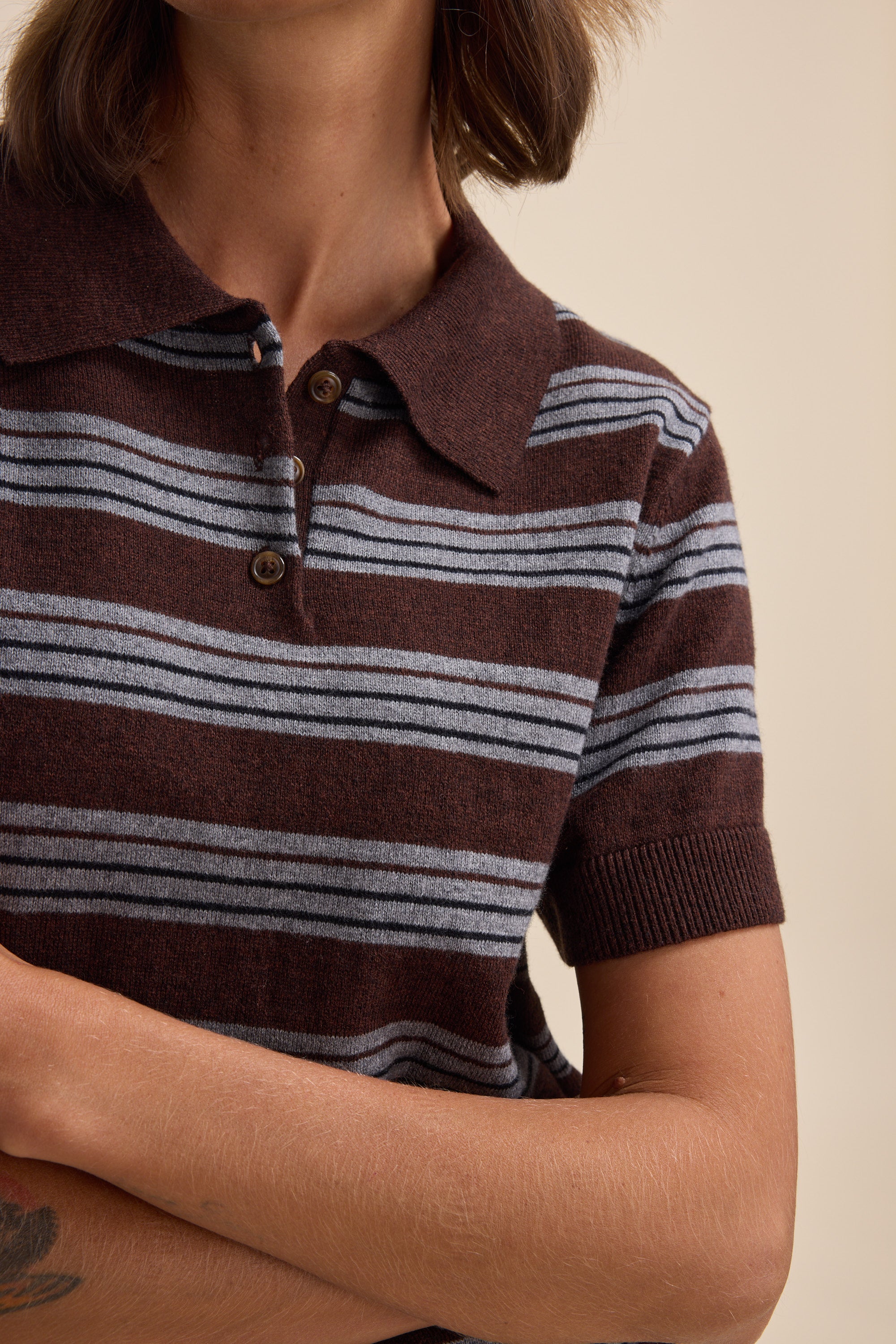Person wears an Elementary Cotton Cashmere Henley by Elementary, arms crossed.