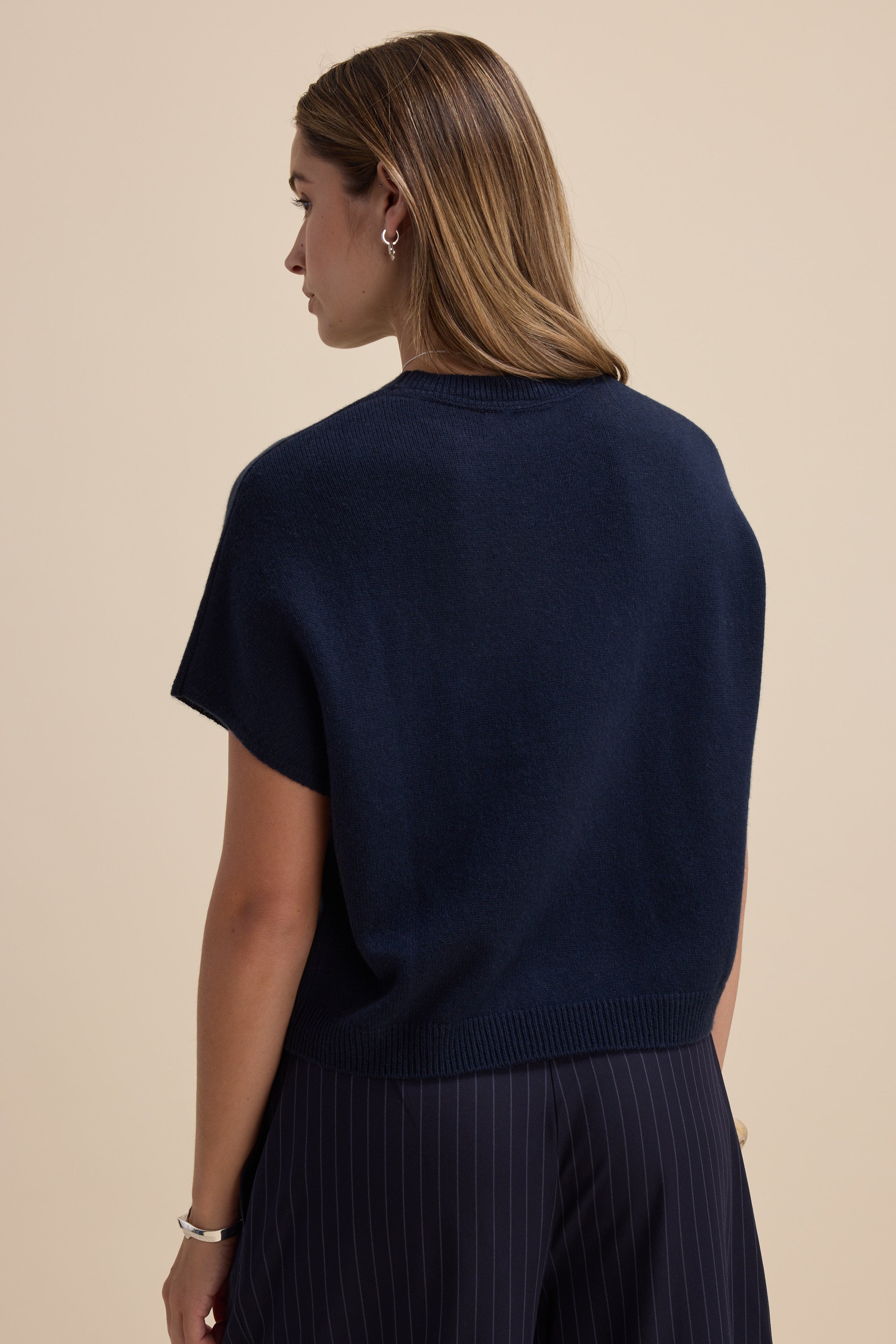 Woman with long hair in Elementary Cashmere Blend Drop Shoulder Top, seen from the back.