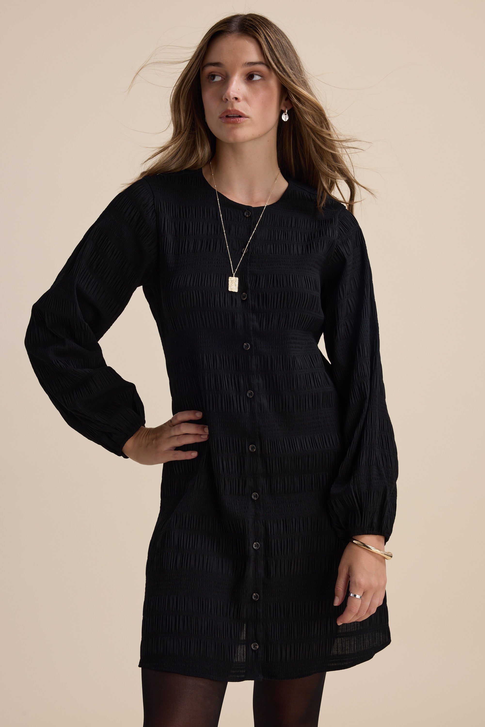 Woman wearing the Max Tessa Textured Button Front Dress, styled with gold jewelry.