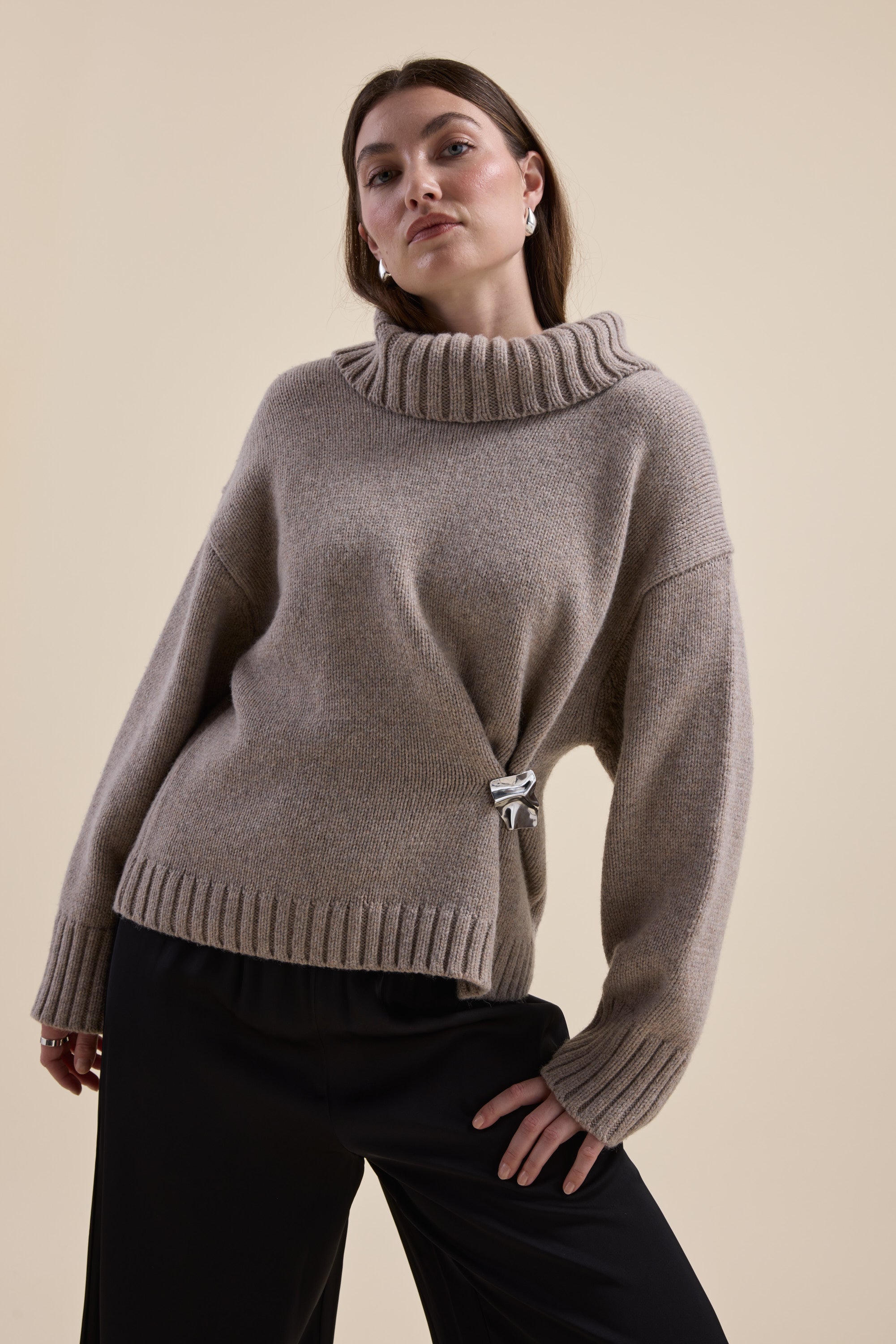 Woman wearing Max's Holly Wool Blend Roll Neck Sweater in beige poses against a plain background.