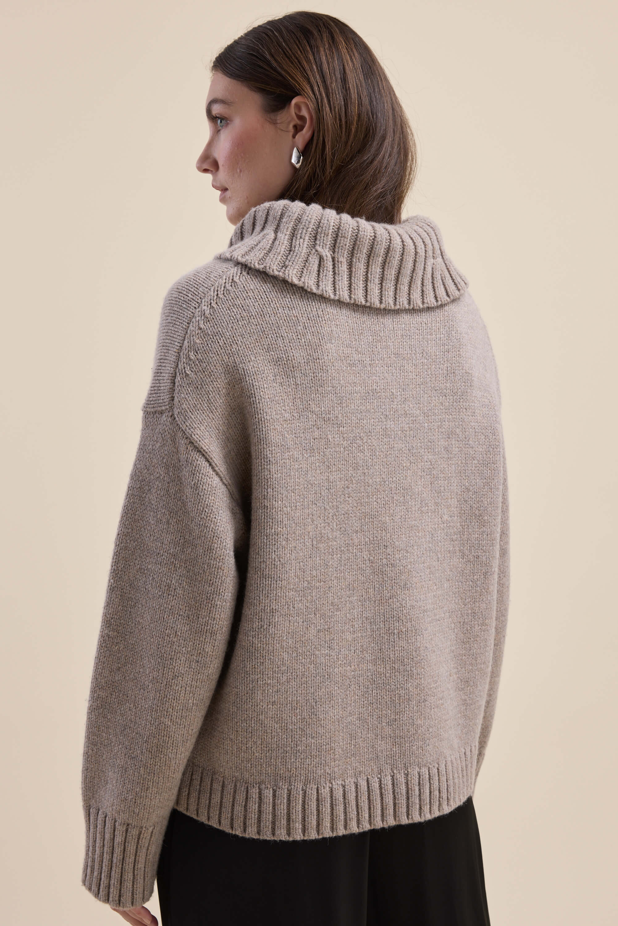 Woman in Max Holly Wool Blend Roll Neck Sweater, beige, shown from the back.