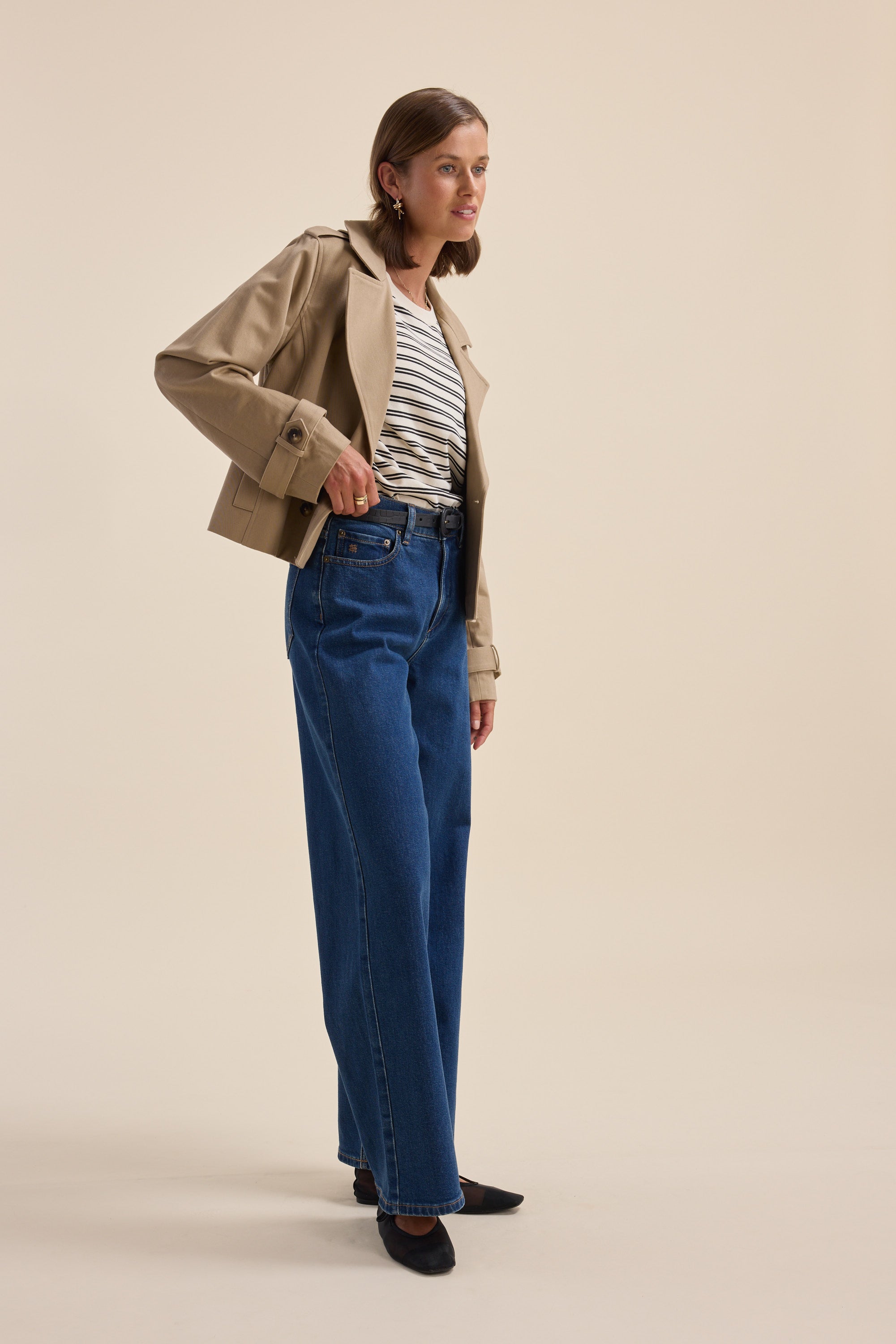Woman wears Max Charmaine Organic/Pima Cotton Tee, blue jeans, and beige jacket.