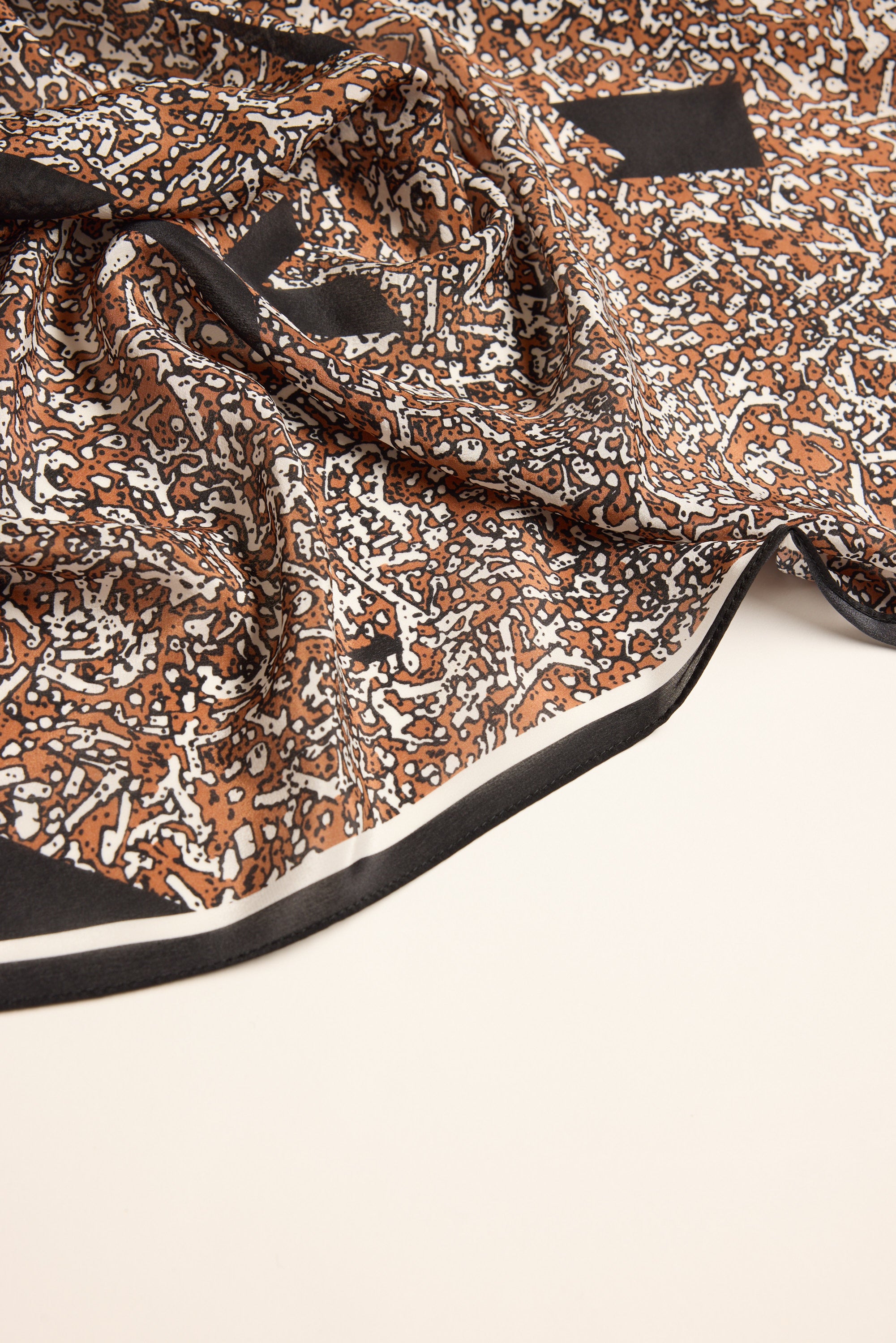 Max Macy Geometric Silk Scarf in brown, white, and black with an abstract geometric design.
