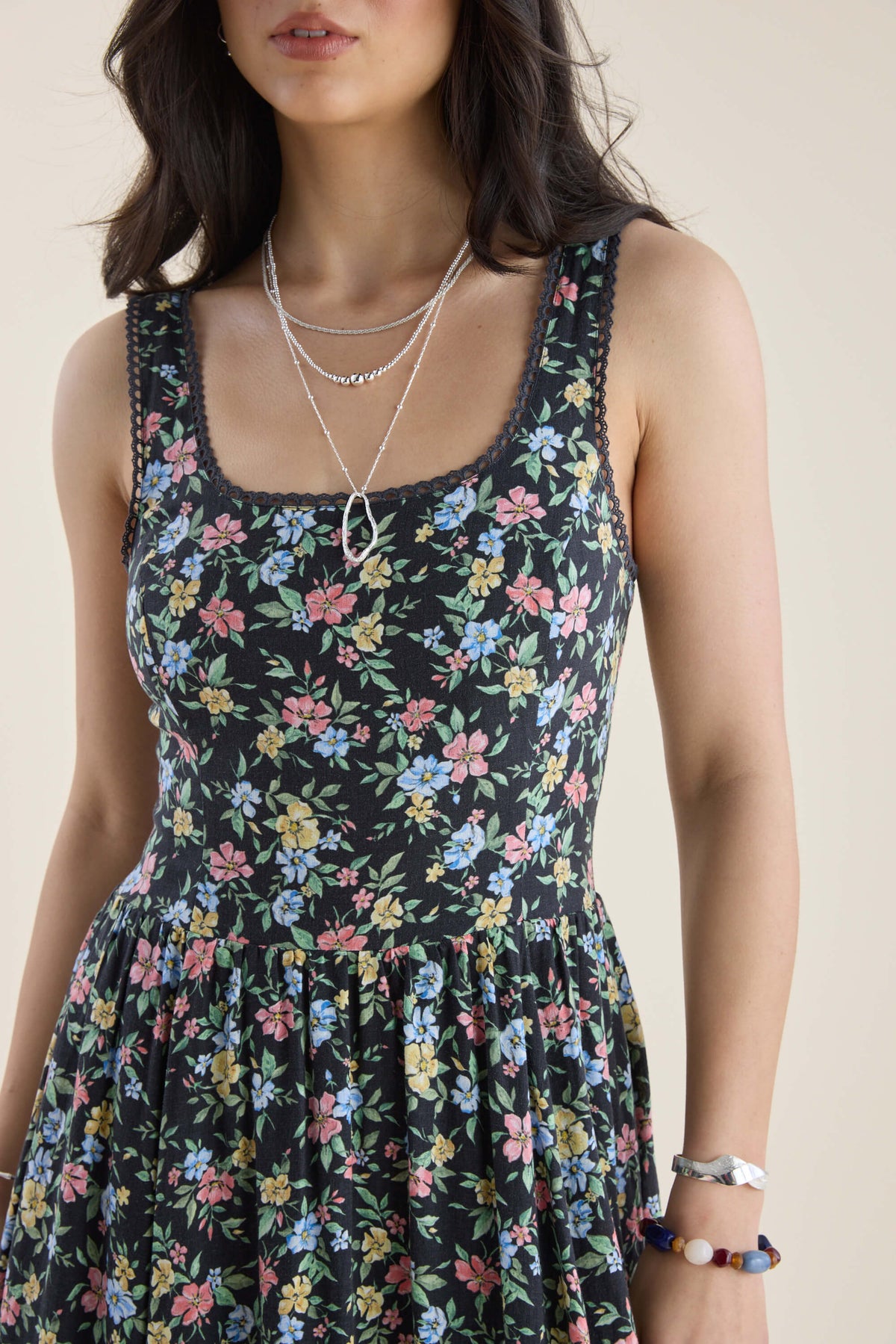 Woman in Max Aria Gathered Waist Midi Dress with layered necklaces, bracelets, plain backdrop.