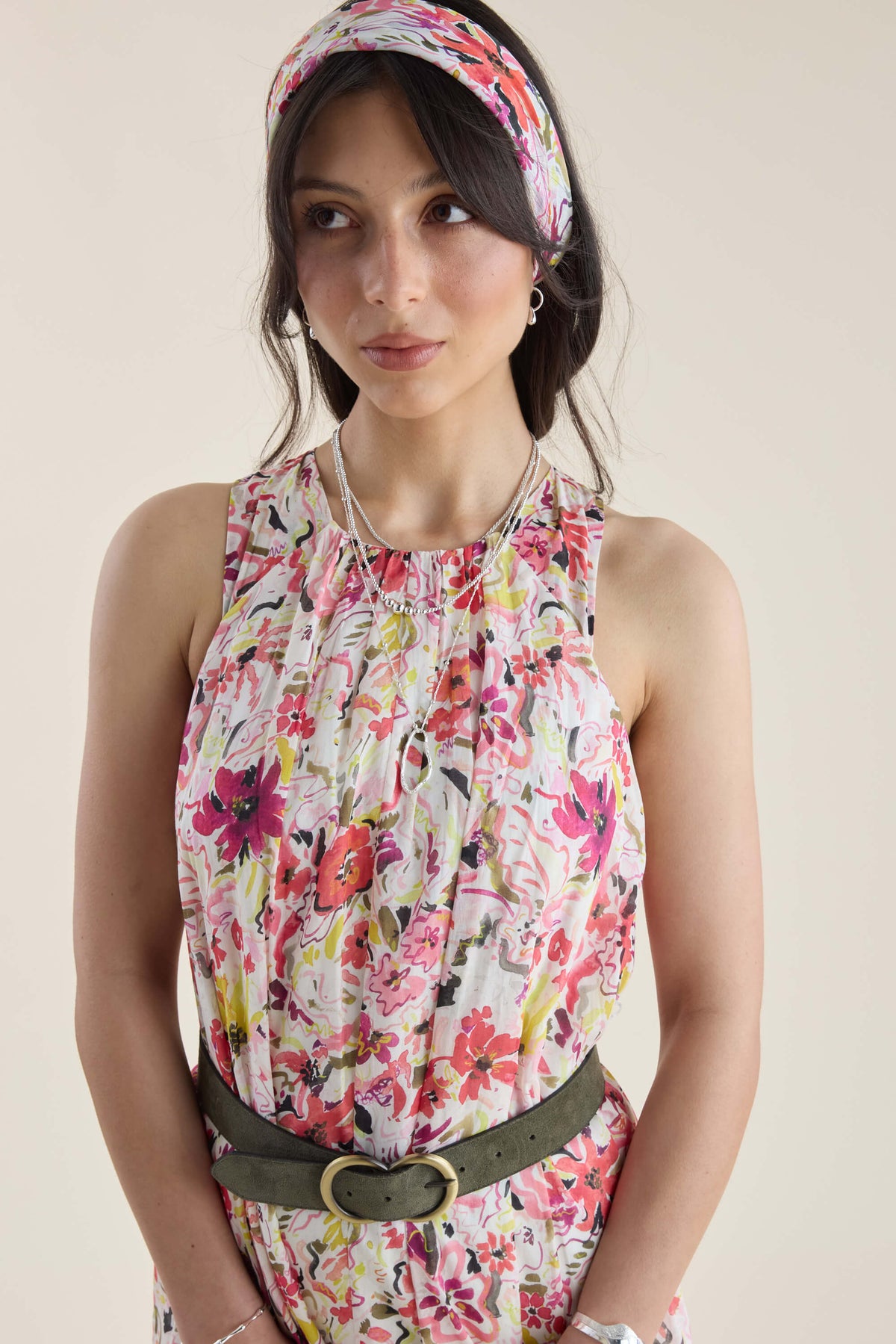 Woman in a Max Kira Back Detail Dress and headband, looking to the side with a neutral look.