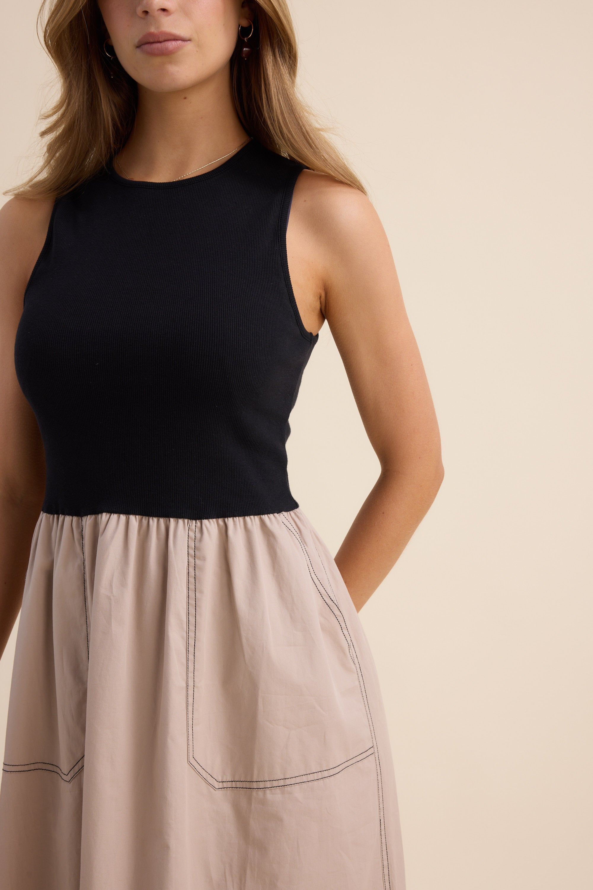 Woman wearing The Stitch Detail Dress by Max, standing against a plain background.