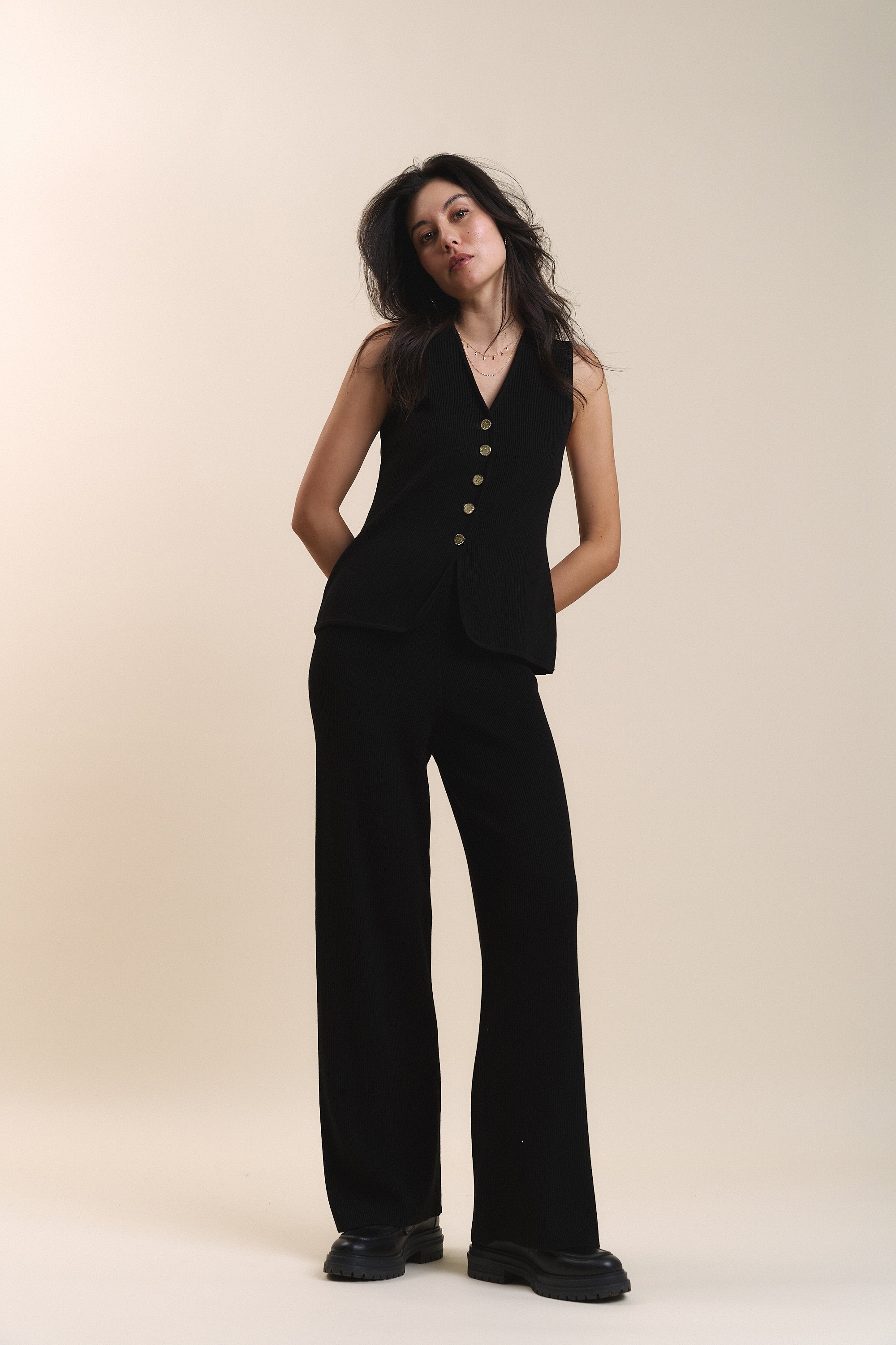 Woman in black ribbed vest and Max Charlie Knitted Pants.