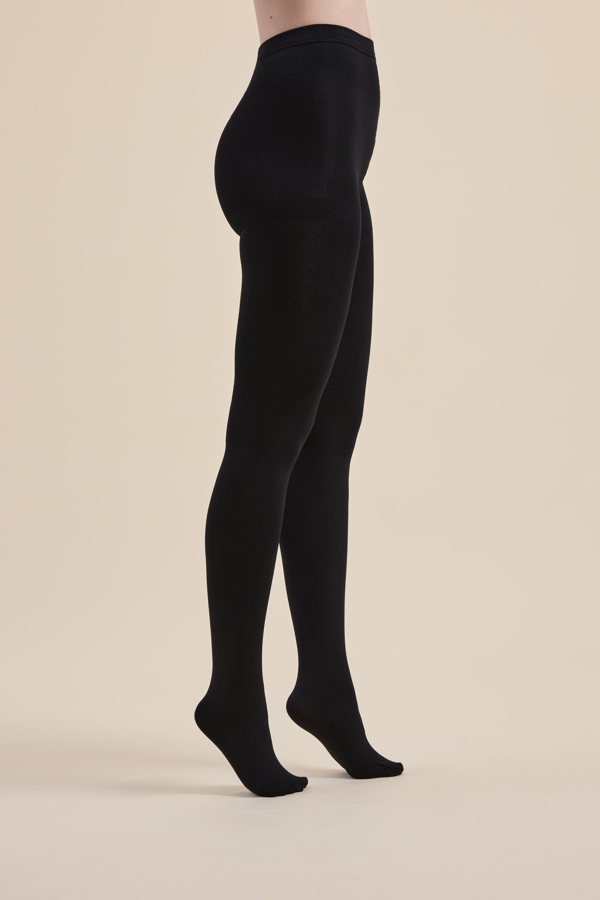 Model wears Max Recycled Fleecy Tights, standing against a plain beige background.