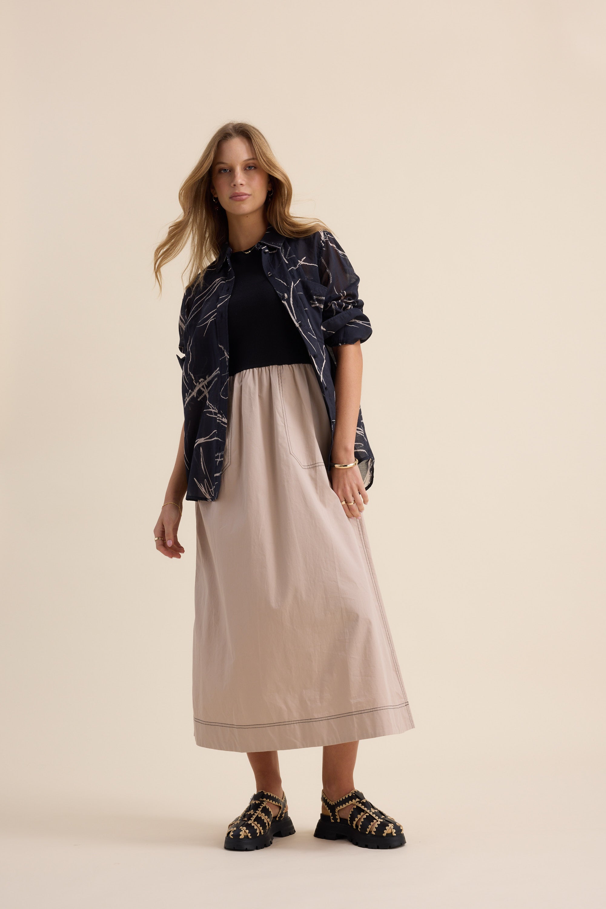 Woman in The Stitch Detail Dress by Max stands posing.