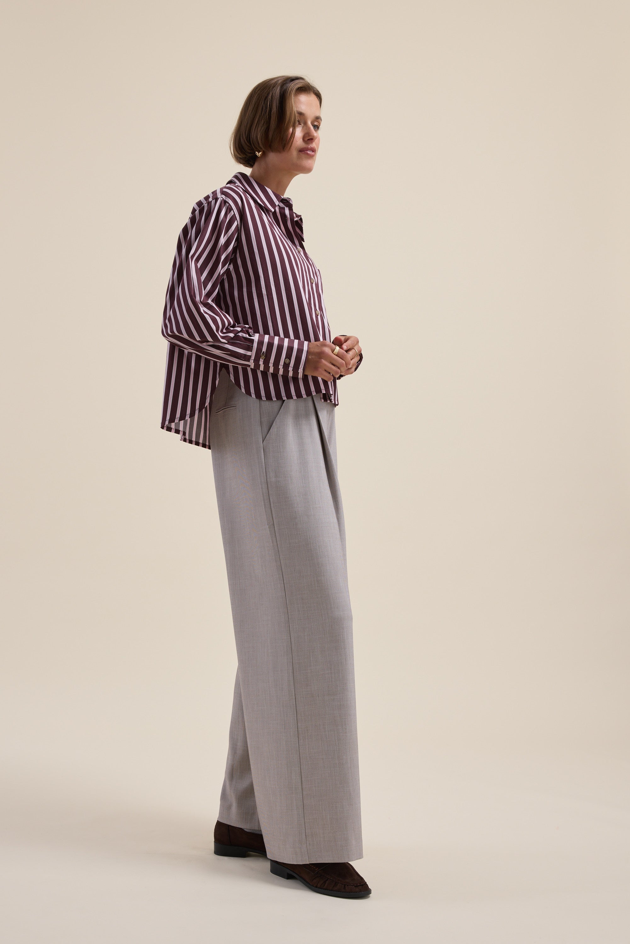 Person wears the Max Leah Stripe Detail Shirt with wide-leg gray pants against a beige background.