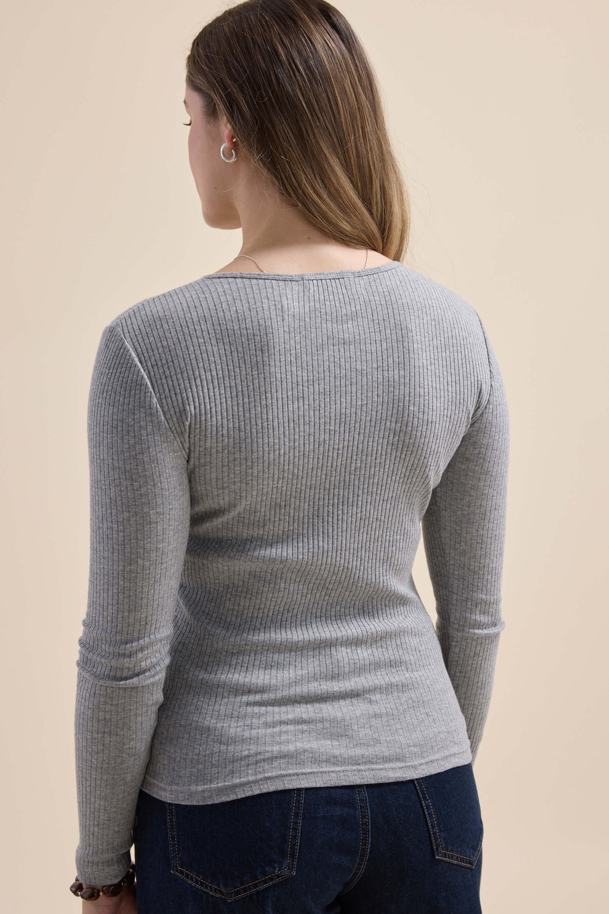 Person in the Elementary Ribbed Henley by Elementary and dark jeans—a classic everyday staple.