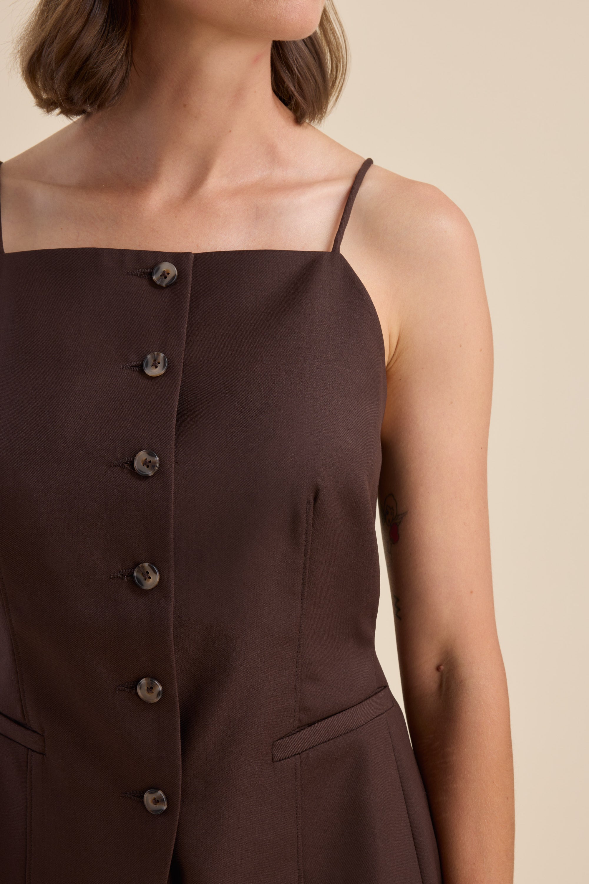 Woman in The Wool Blend Vest by Max, facing sideways against a beige background.