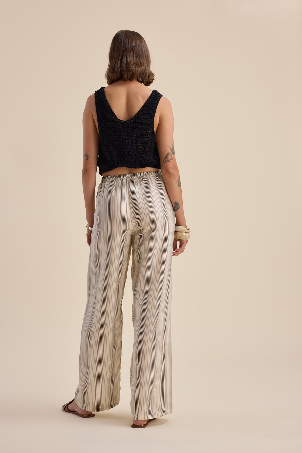 Woman in sleeveless top and Max Sera Drawstring Pants, back to camera.