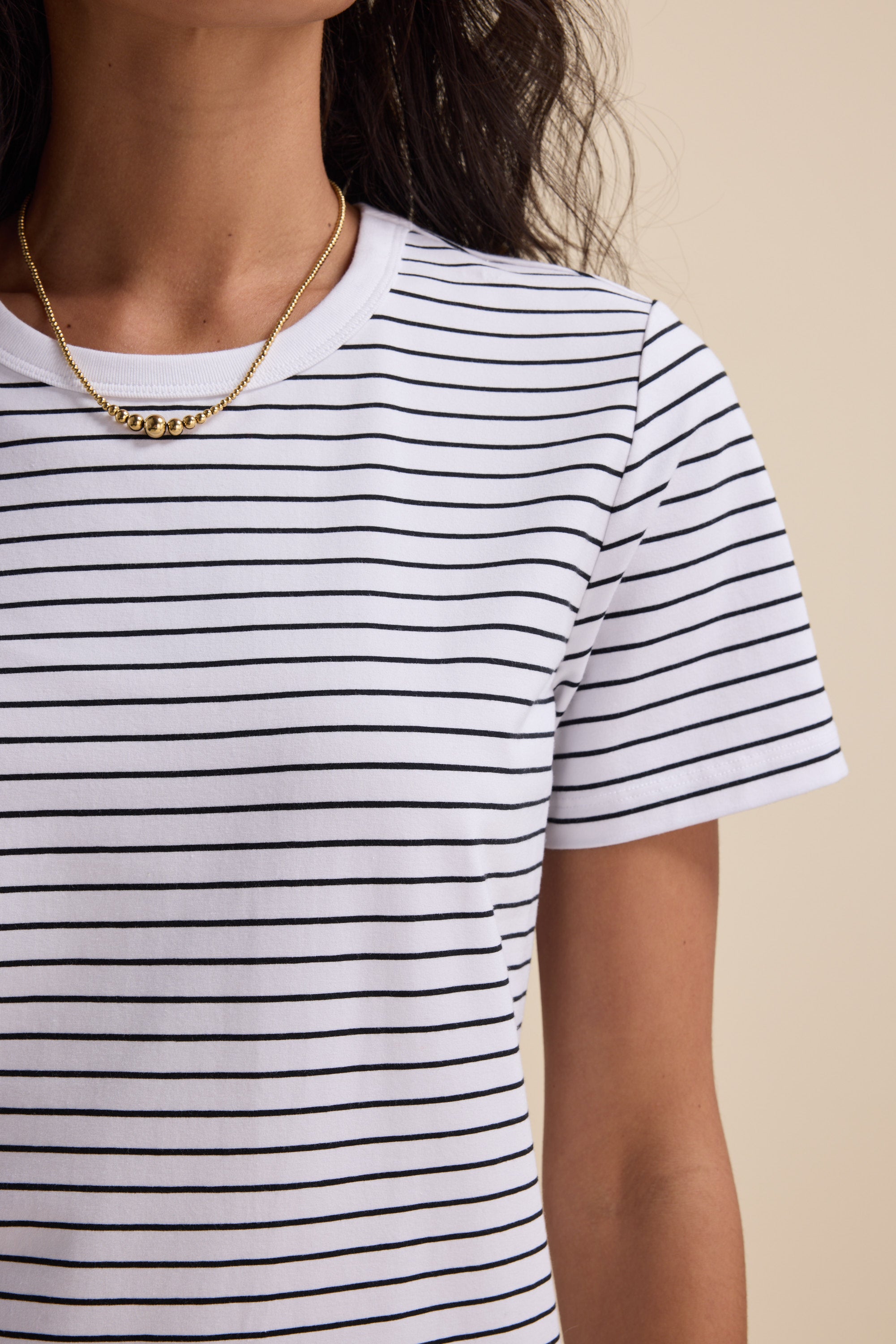 Woman in Max's Perfect Short Sleeve Crew Neck Tee, styled with a gold necklace.
