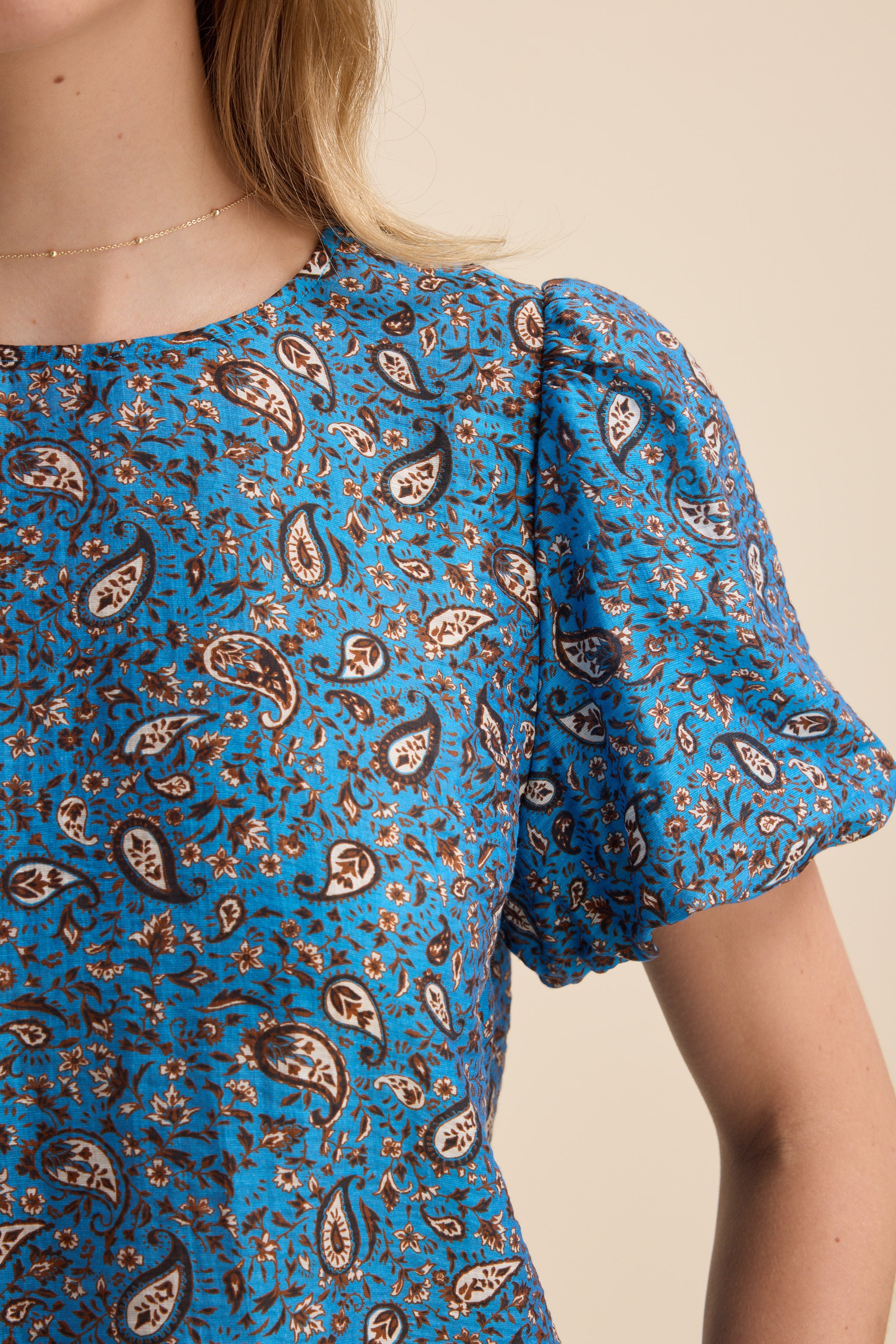 Max Sydney Back Detail Top in blue paisley with puff sleeves, shown from shoulder up.