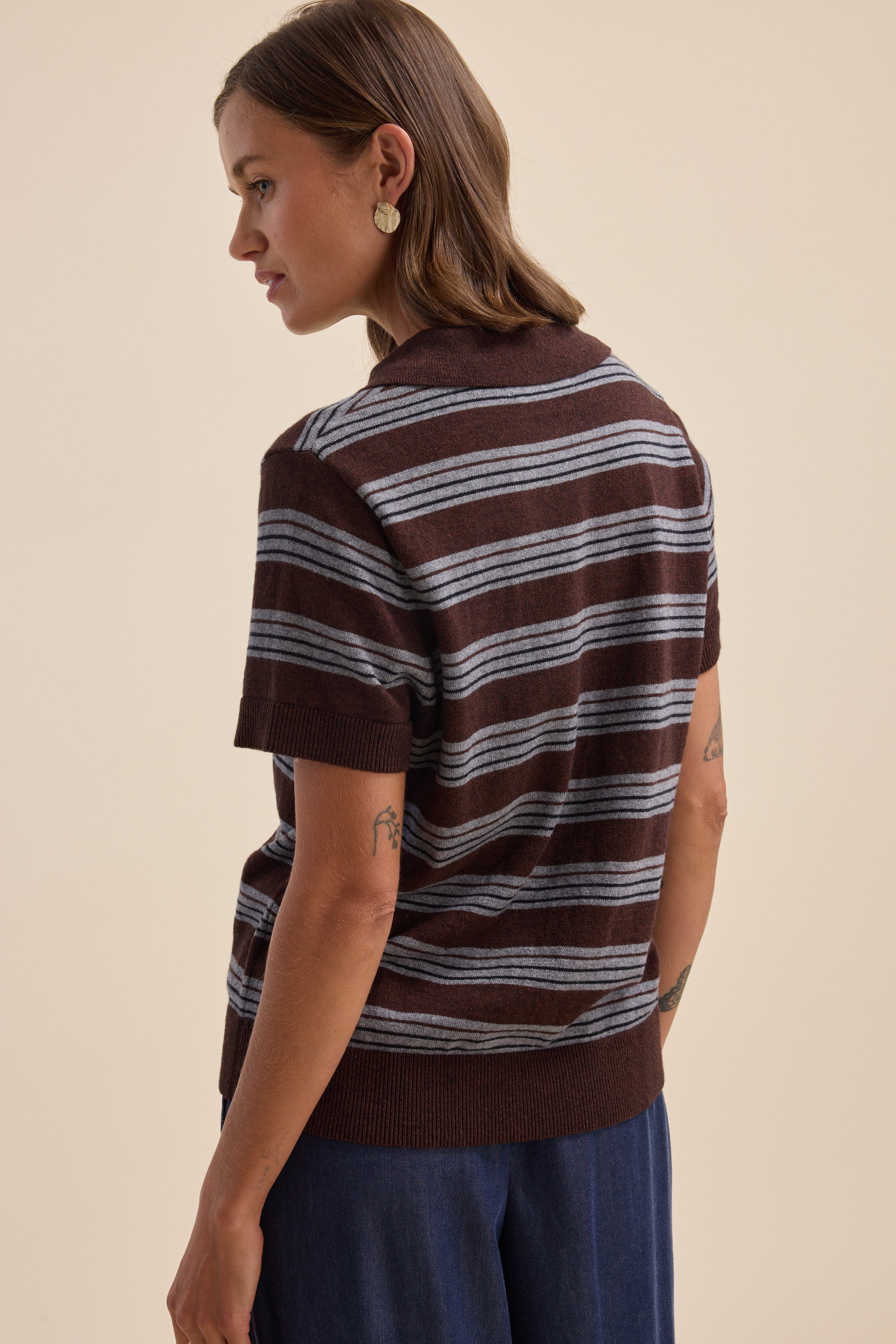 Woman in an Elementary Cotton Cashmere Henley sweater, facing slightly away.