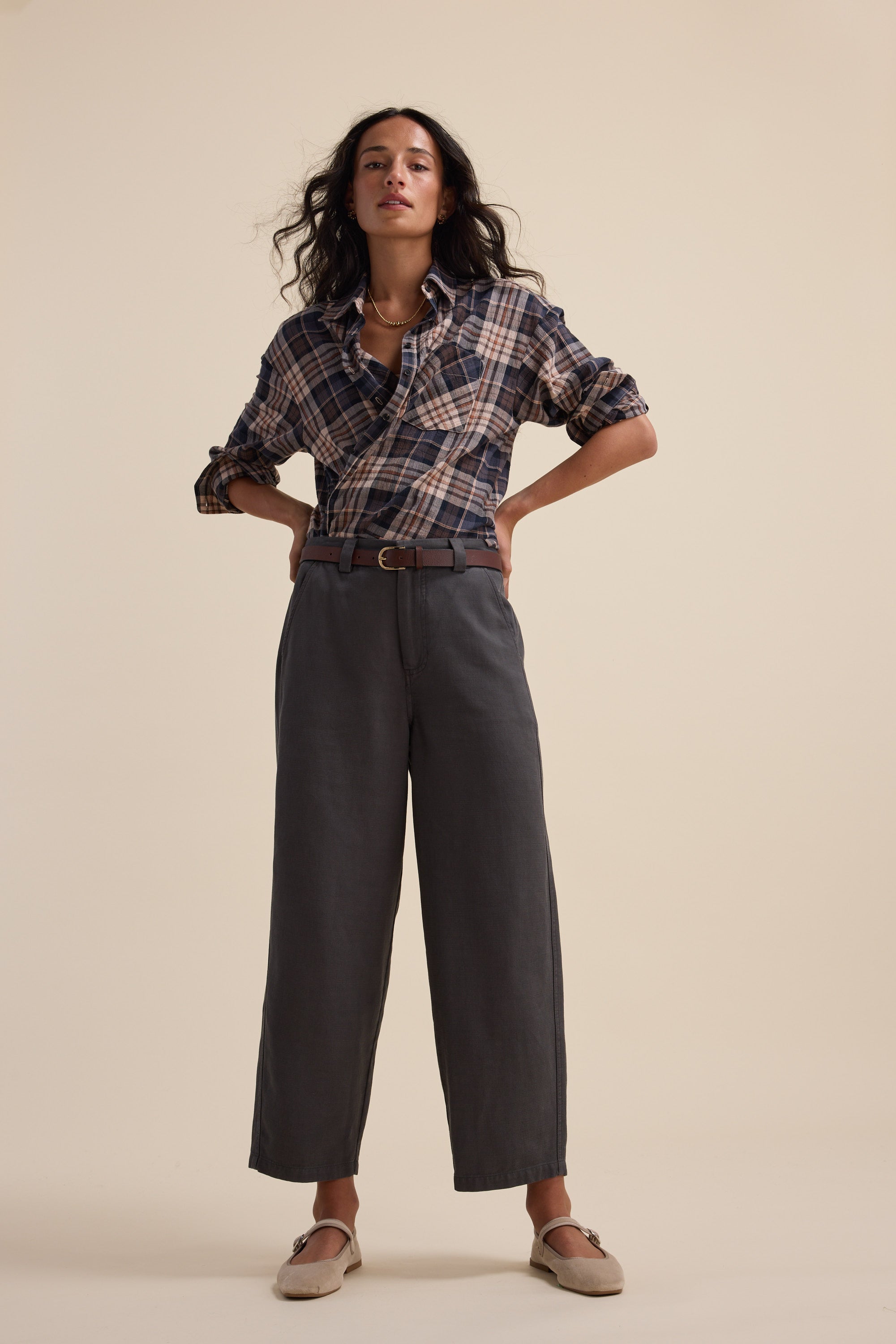 Woman in a plaid shirt and Elementary Panelled Barrel Pants by Elementary, hands on hips.