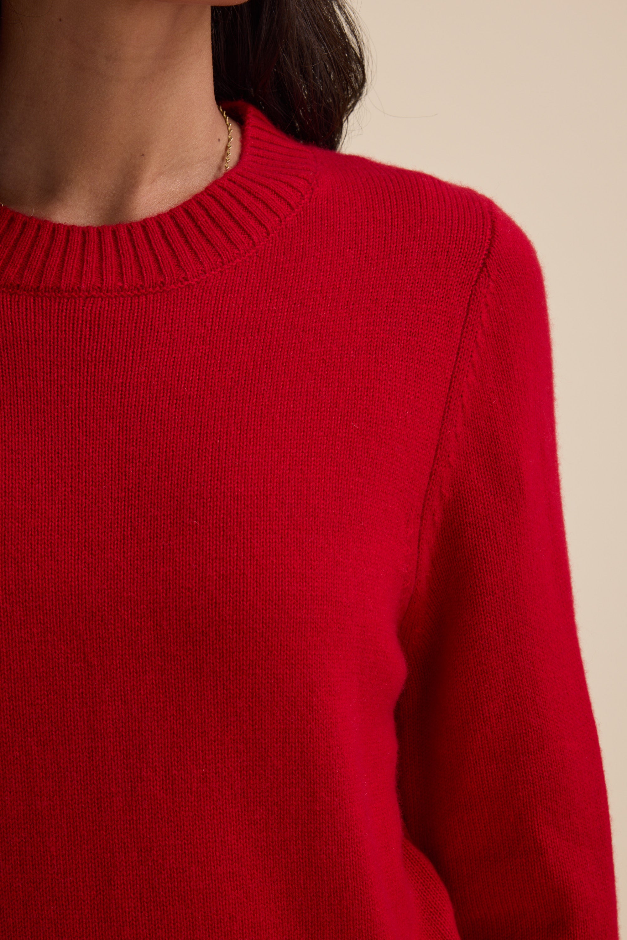 A person wears the Elementary Cashmere Blend Crew Neck Sweater, shown from shoulders to chest.