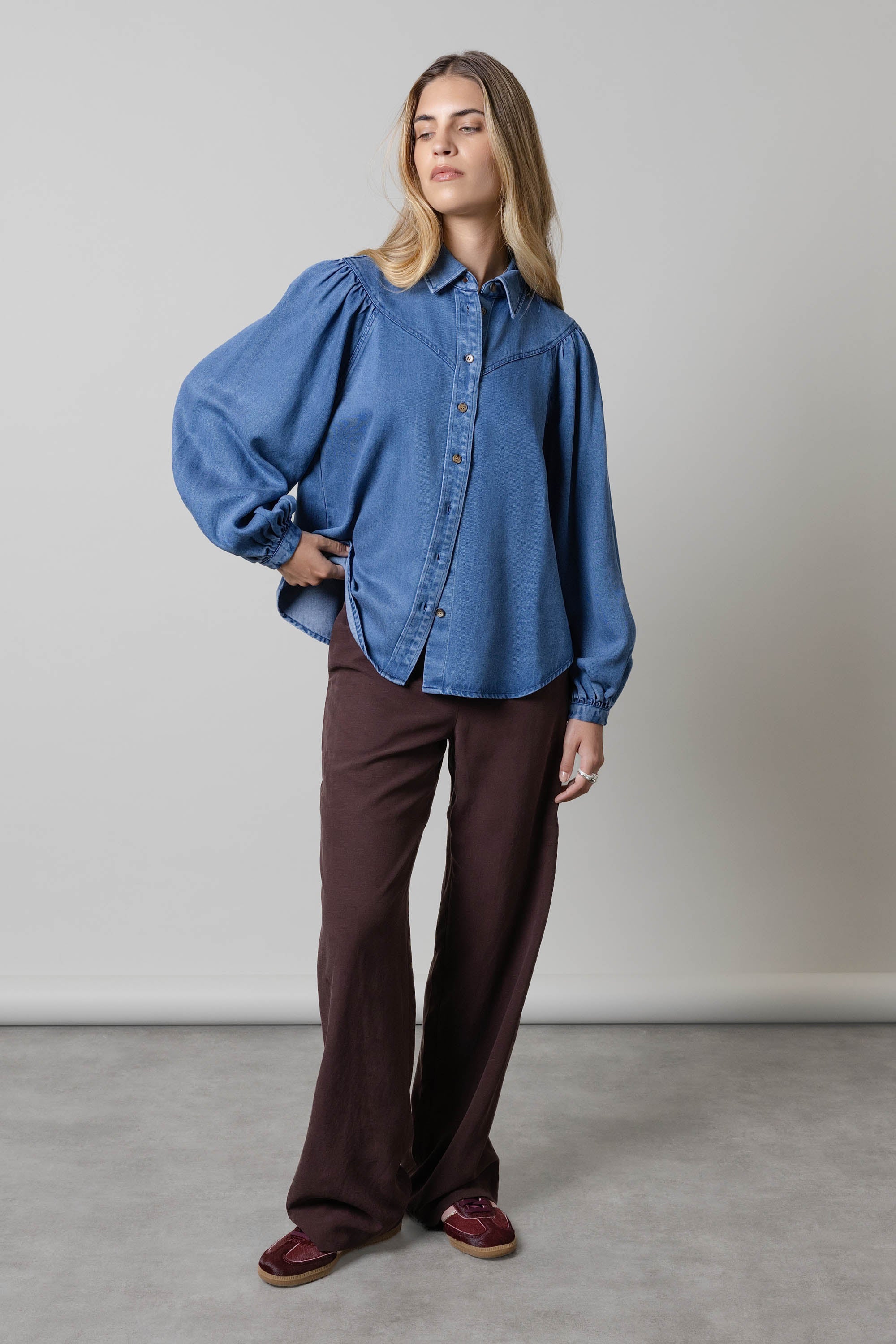 Woman wearing the Elementary Denim Shirt by Elementary with blouson sleeves.
