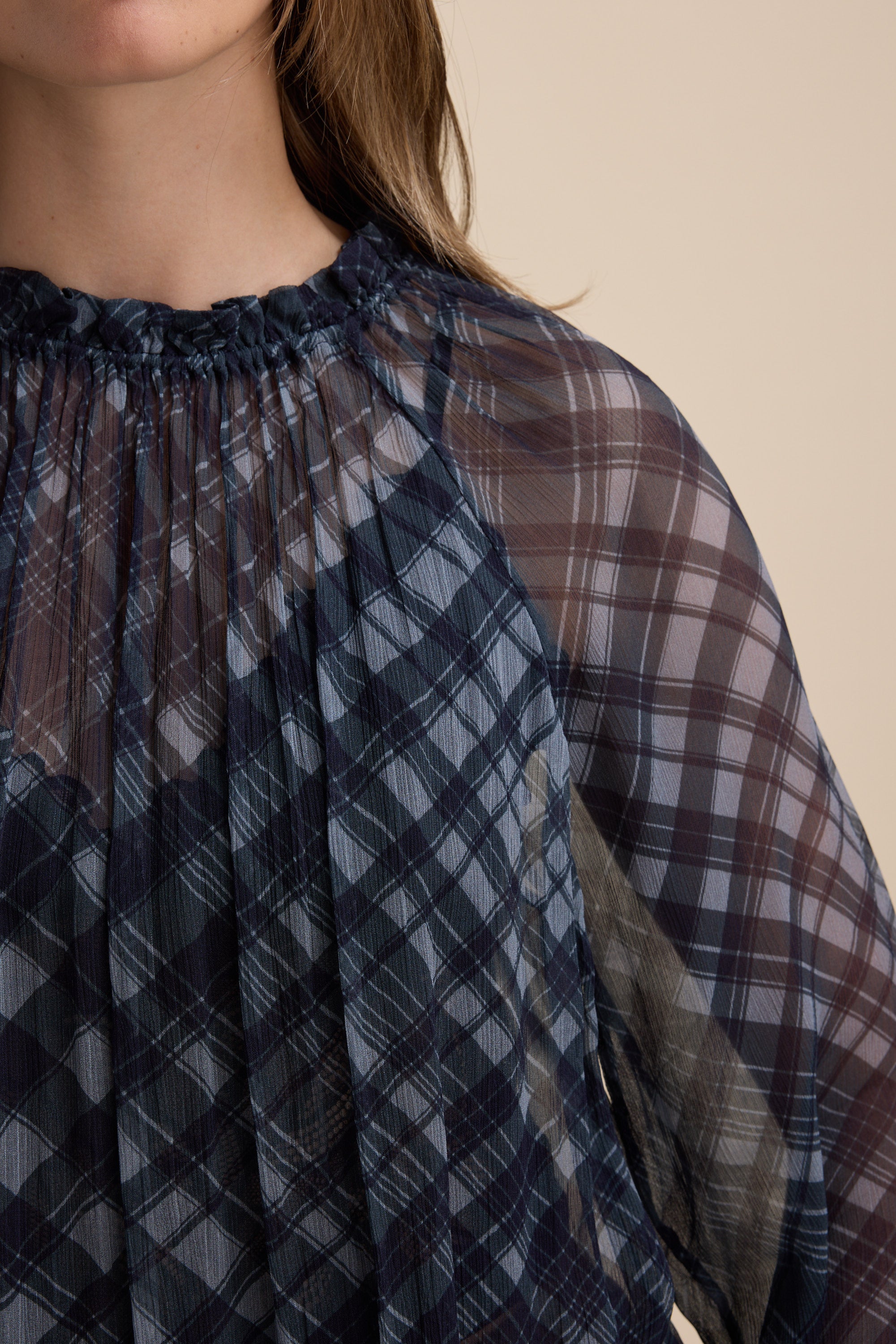 Close-up of a Max Quinn Gather Detail Blouse, sheer navy check with pleated details.