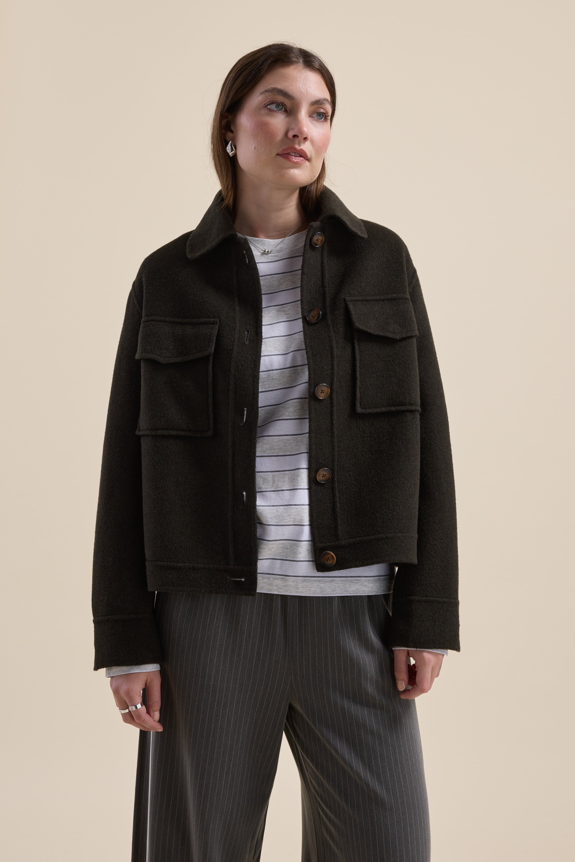 Woman in Max Kaia Wool Blend Cropped Coat over striped shirt and gray pinstripe pants.