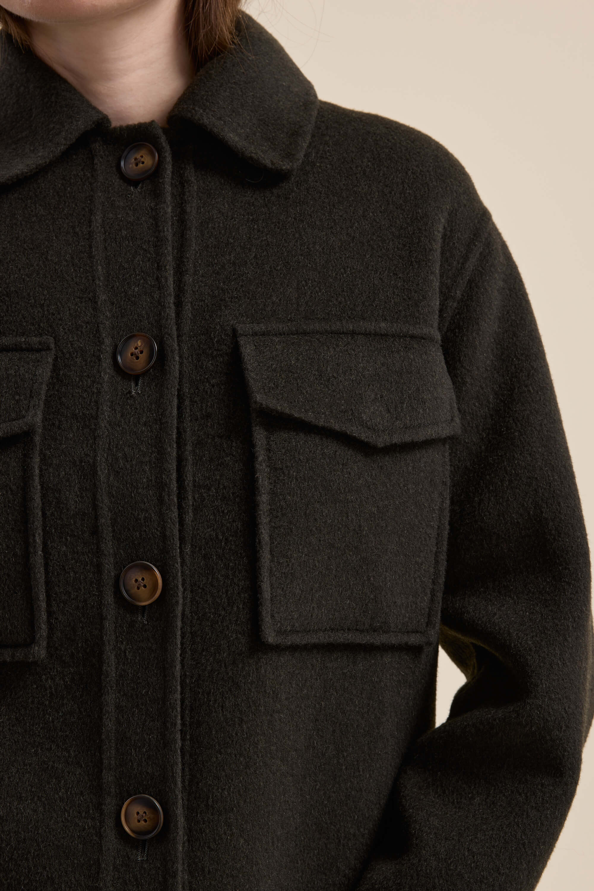 A person wearing the Max Kaia Wool Blend Cropped Coat with large buttons and front flap pockets.