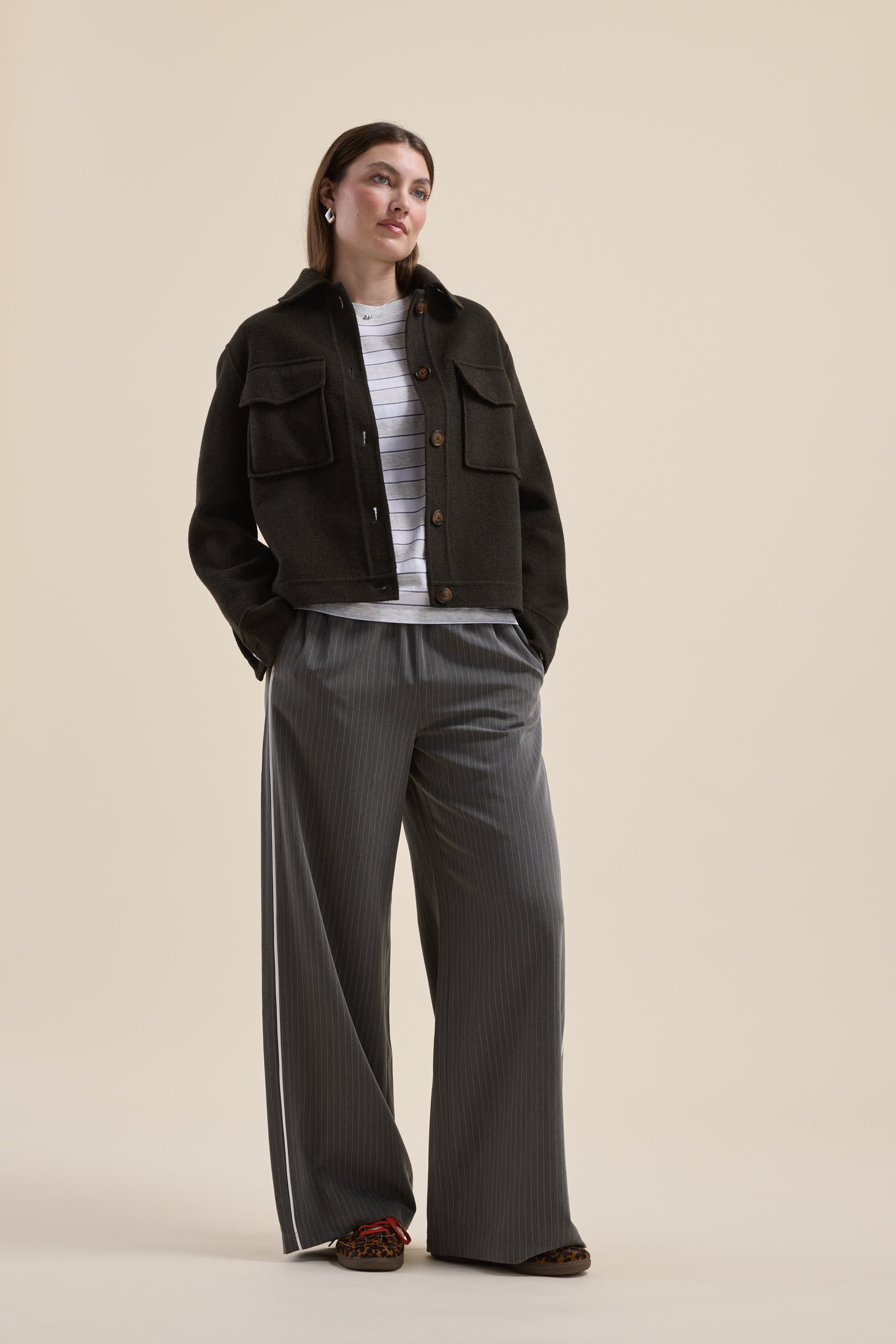 Woman in Max Kaia wool blend cropped coat, wide-leg pinstripe pants, and striped shirt.