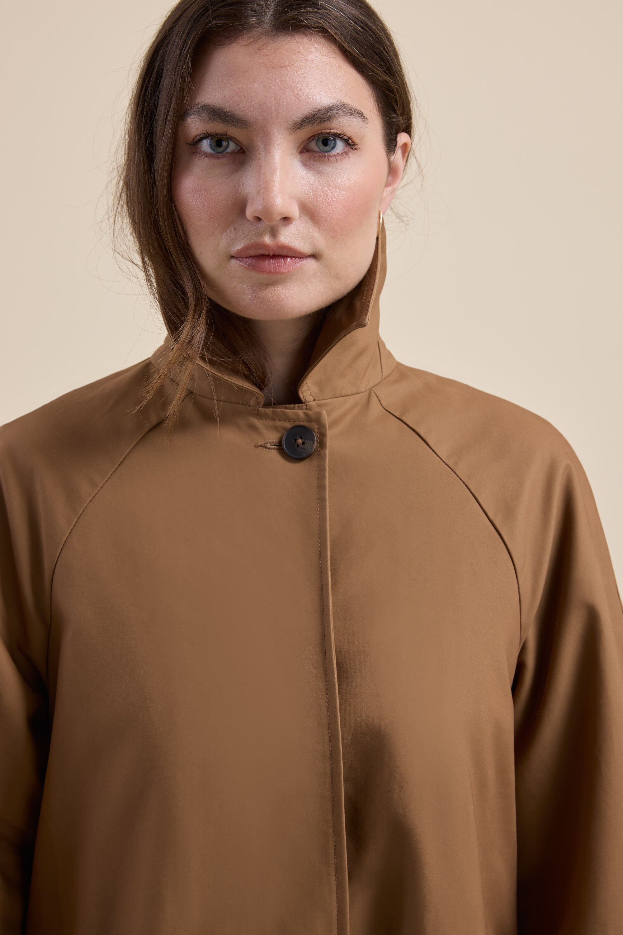 Woman in a brown London Trench Coat by Max, looking directly at the camera.