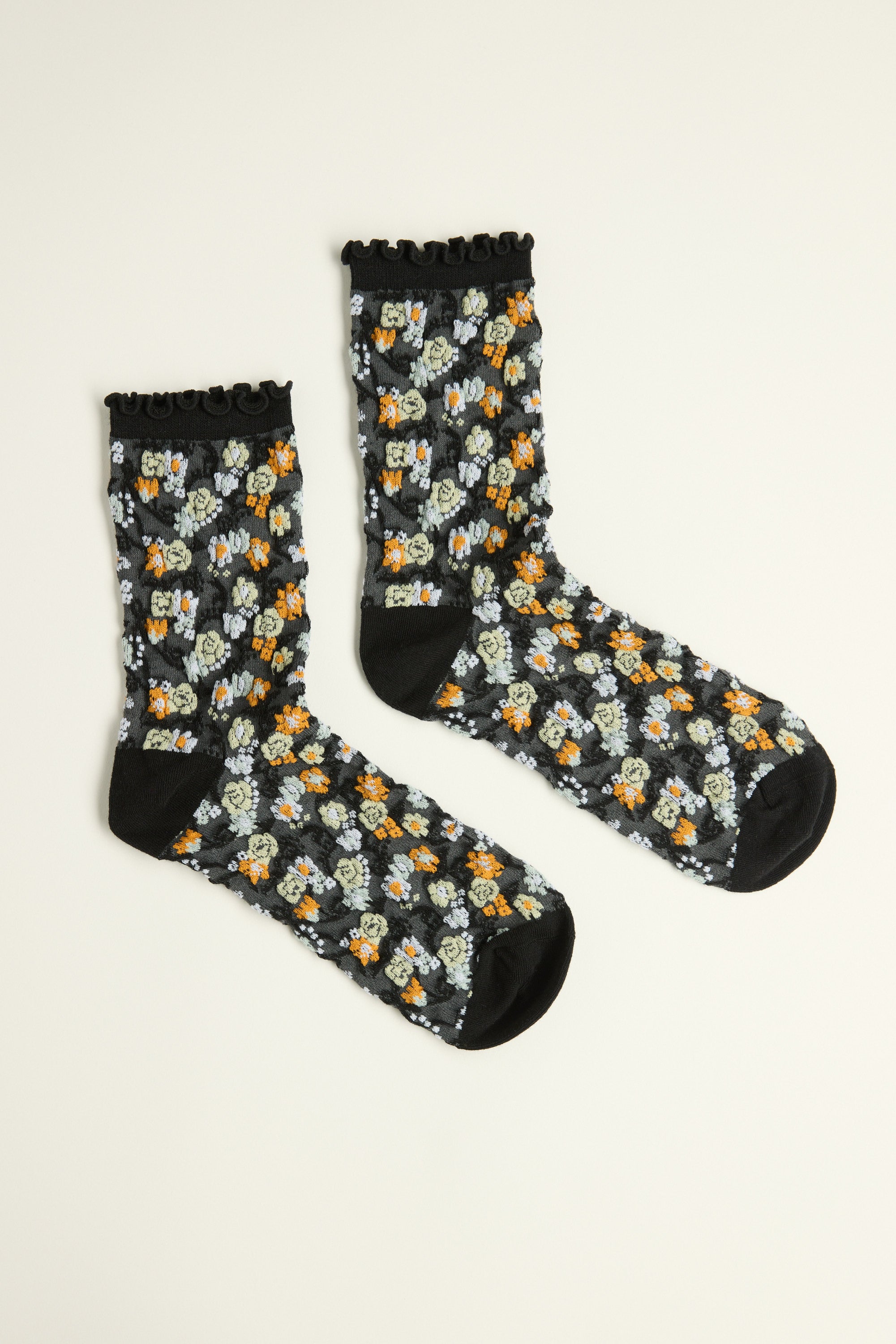 Max Jodi Floral Crew Socks feature colorful flowers and lettuce frill trim on black.
