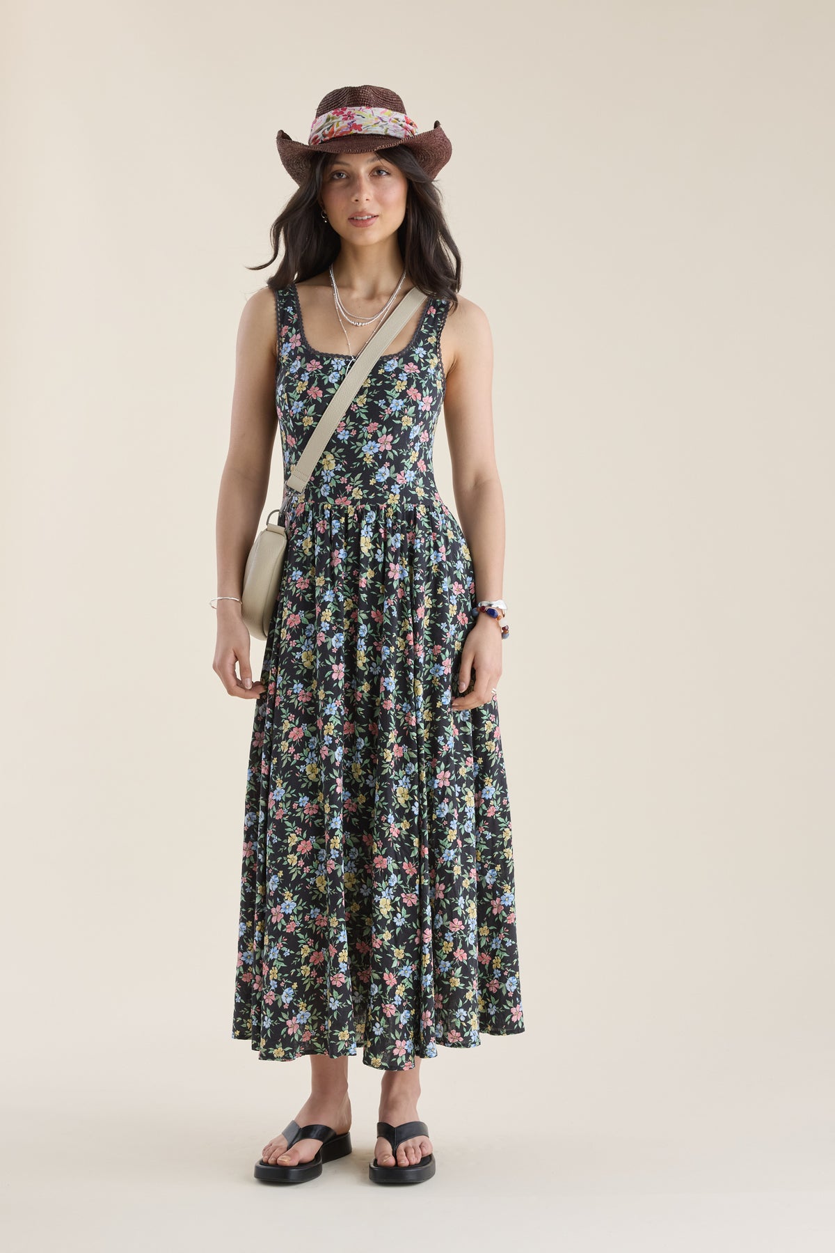 Woman in Max Aria Gathered Waist Midi Dress, hat, sandals, and crossbody bag.