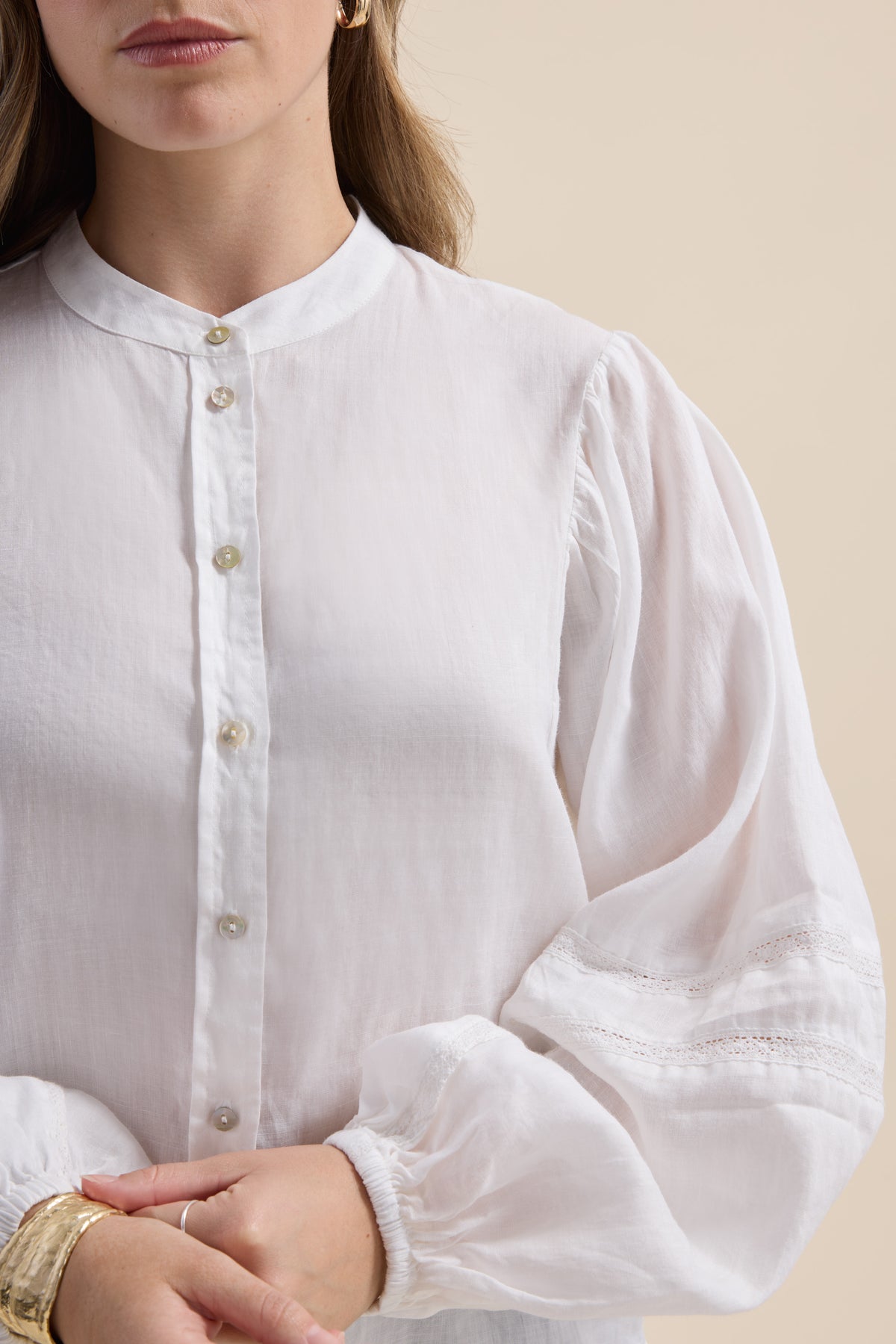 Woman in Max’s Millie Trim Detail Blouse, styled with gold jewelry and a bright smile.