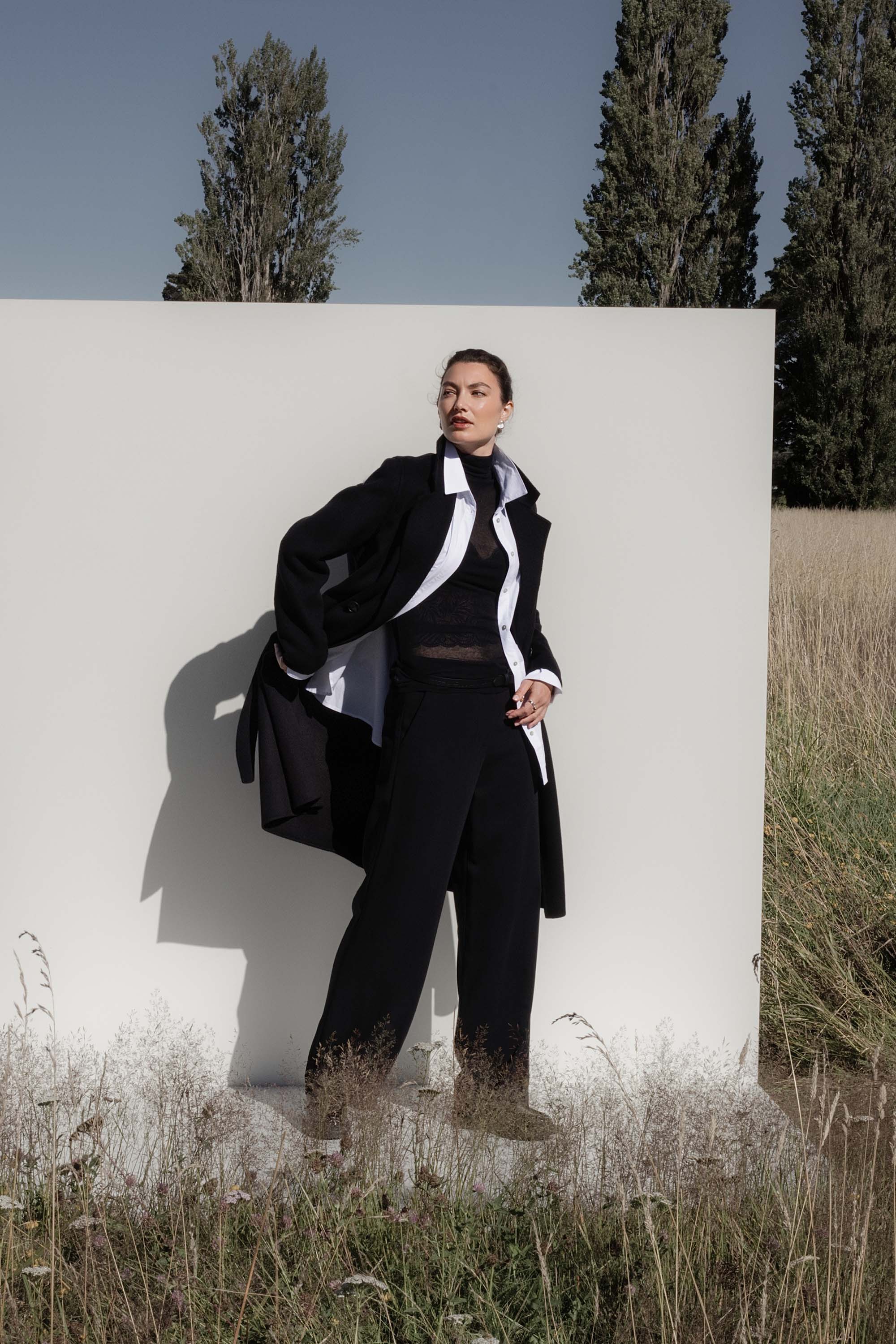 Max’s The Belted Wool Coat brings confidence to any outdoor look against a white backdrop.
