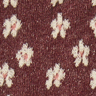 Maroon NZ fabric with small white and pink flower patterns.