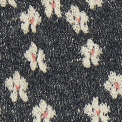 Close-up of NZ black fabric with a small white and pink floral pattern.